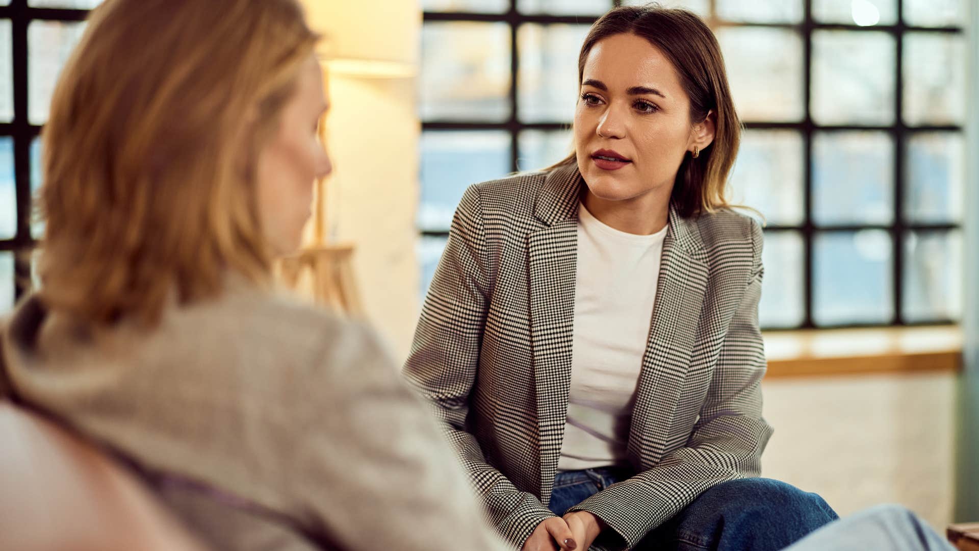 Woman saying "I don't think they'd notice if I left" to a friend.