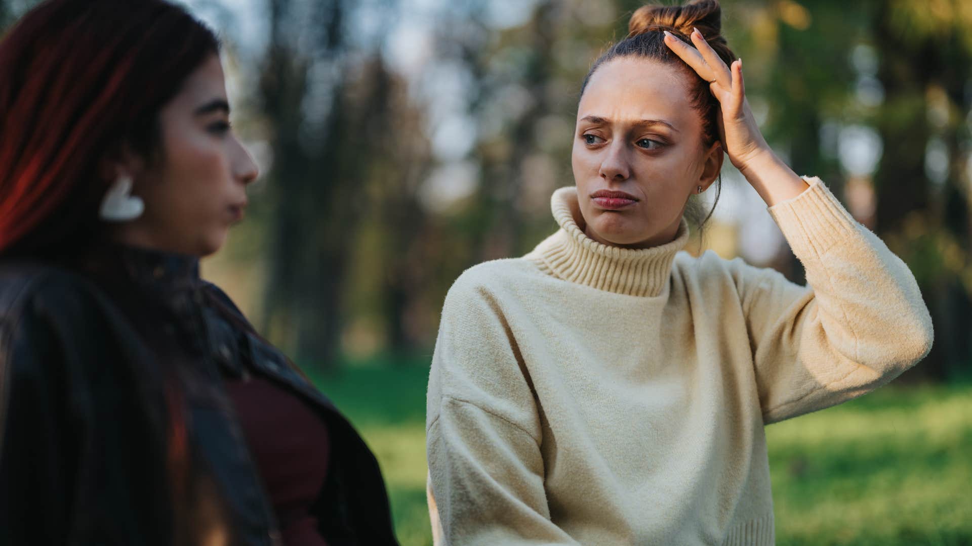 Serious woman saying "I fantasize about being single" to her friend.