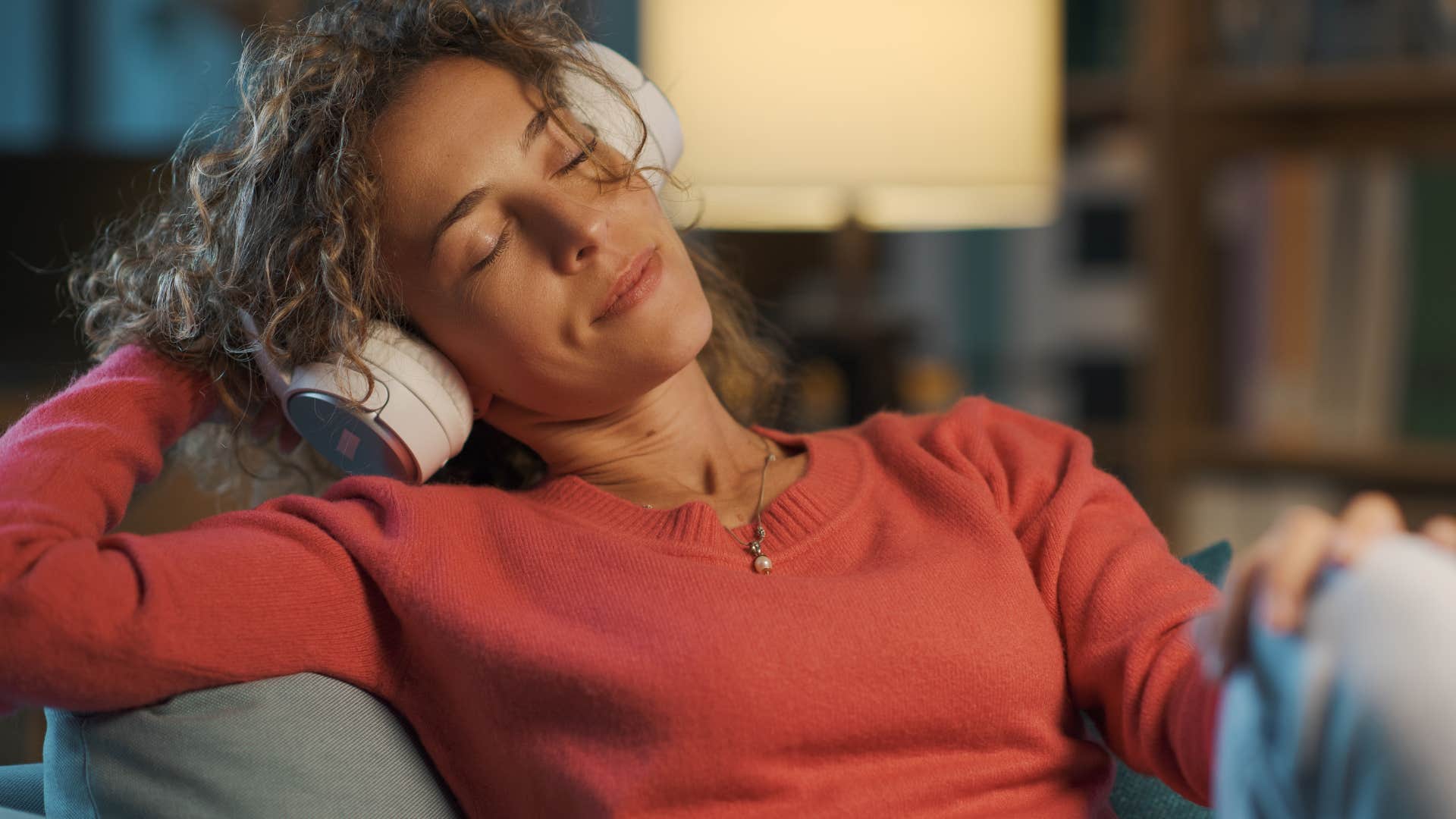 woman being authentic and listening to music at home