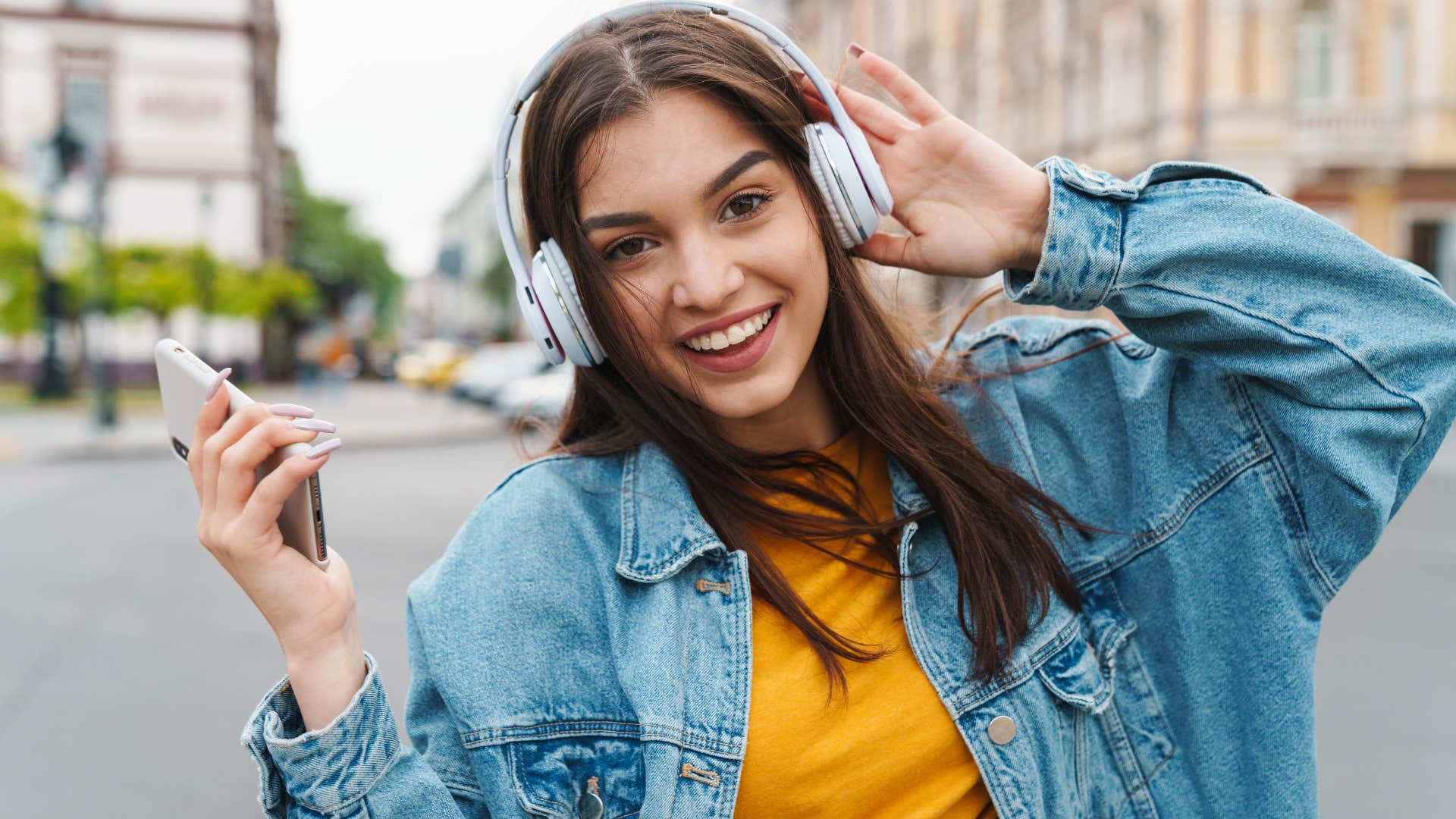 woman listening to music outside feeling open