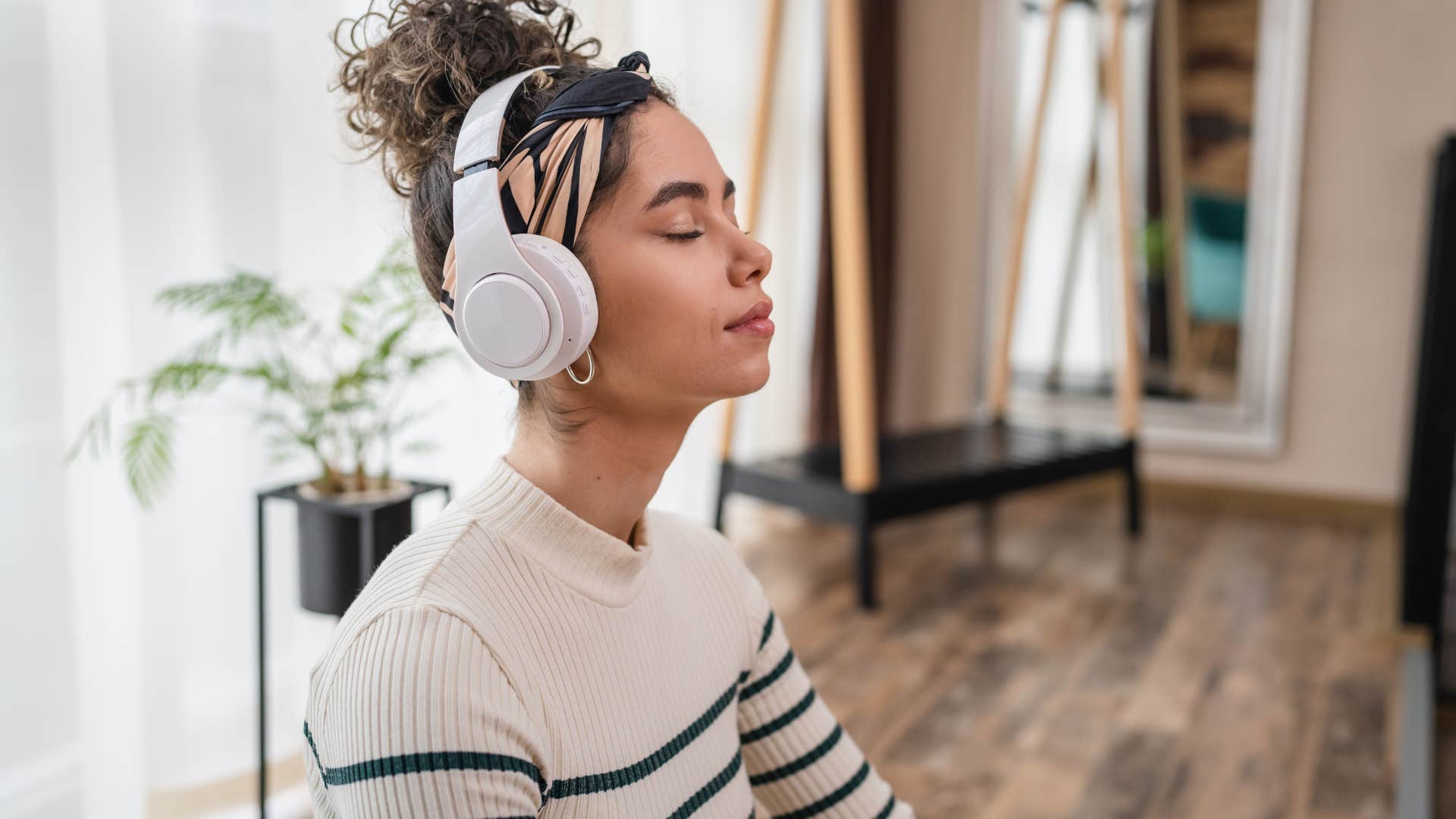 passionate woman with headphones on meditating