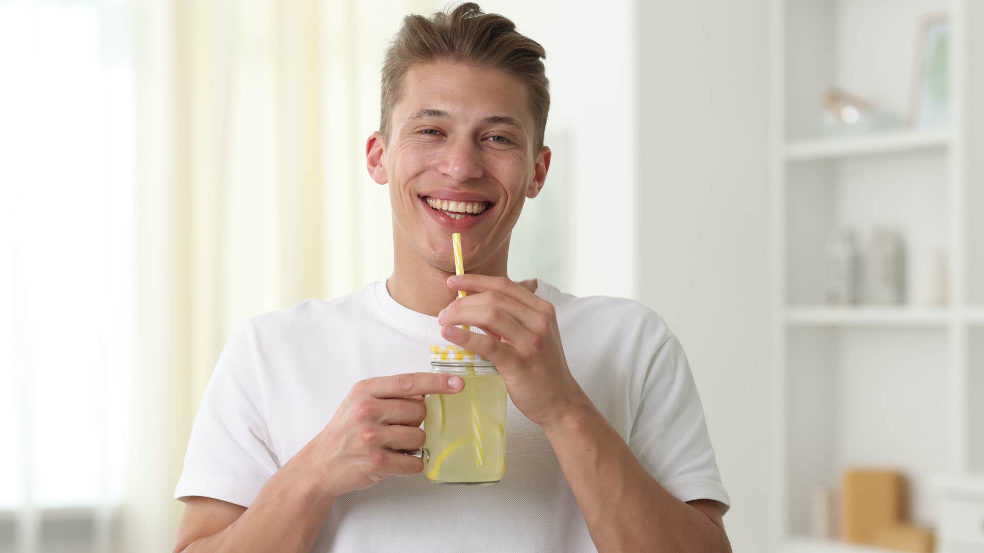 southern man drinking from mason jars at home