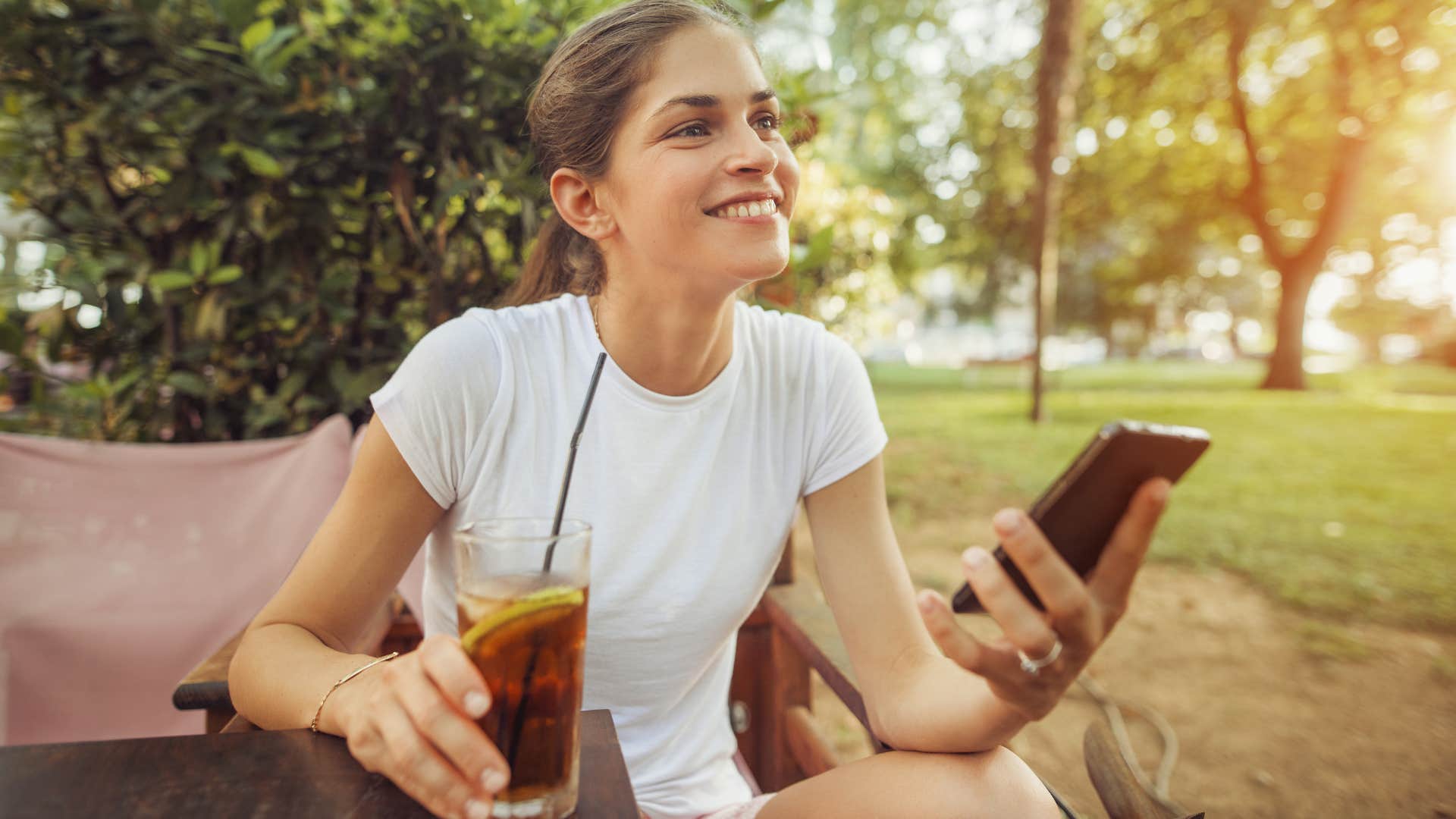 woman drinking a glass of sweet tea outside