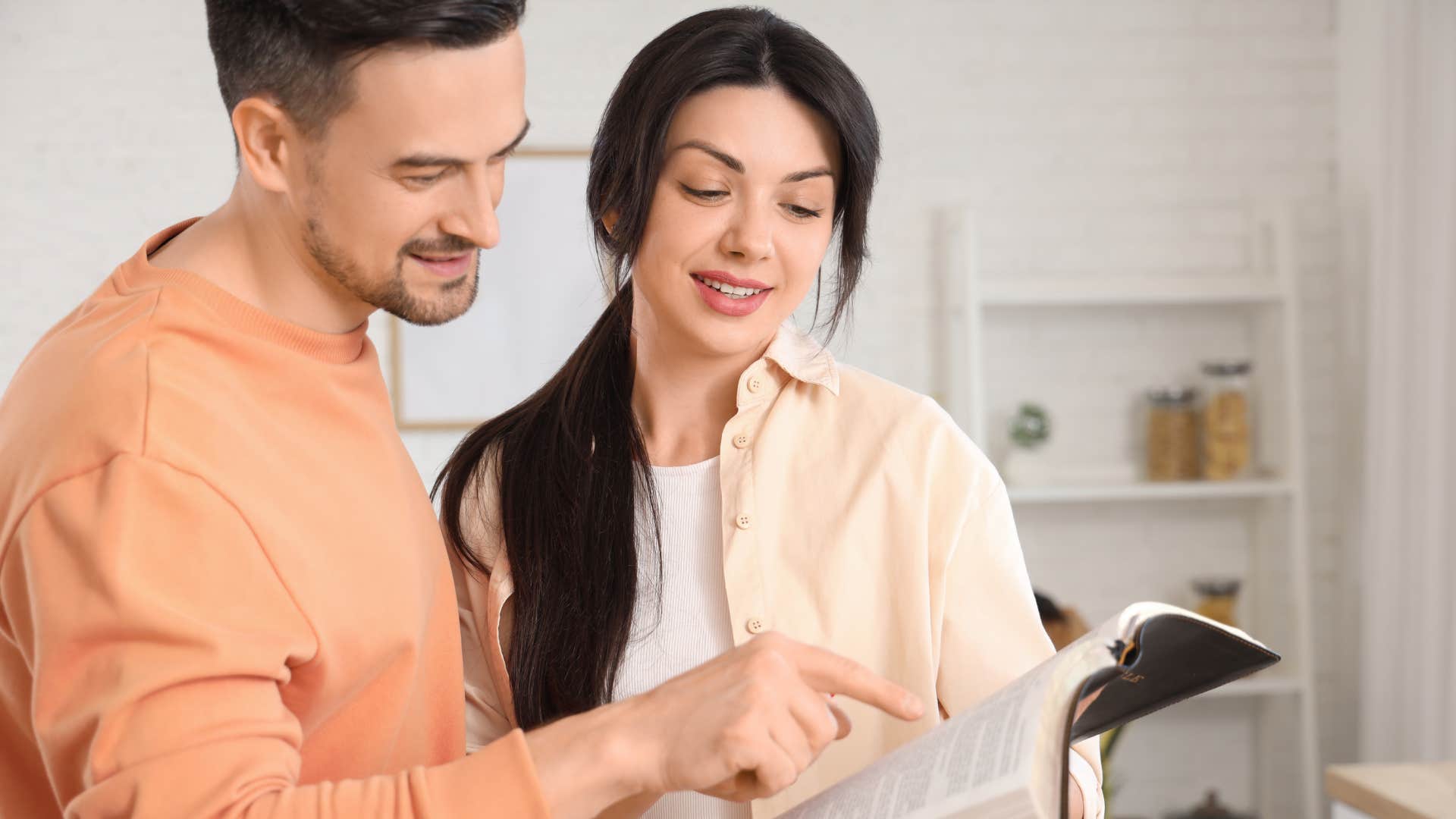 couple looking at religious scripture at home