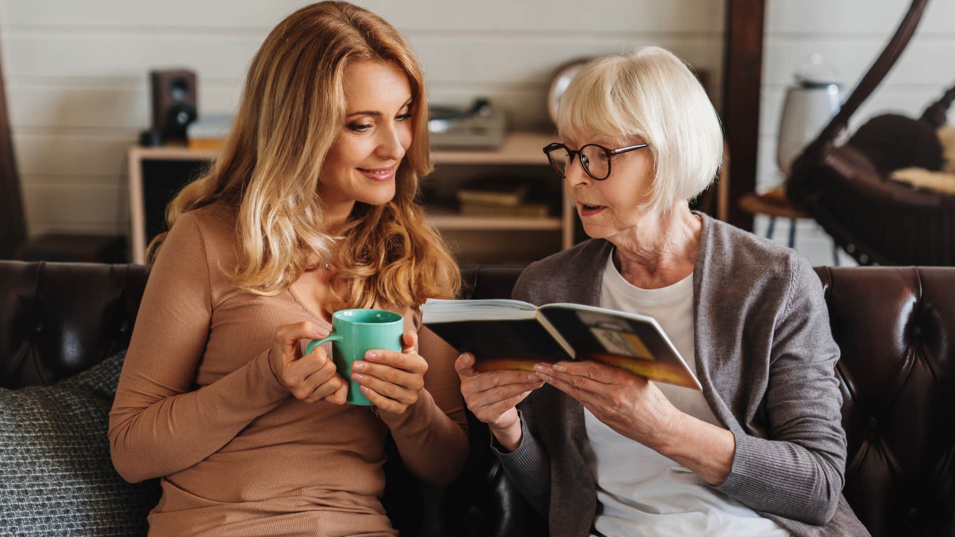 woman looking at tons of family photos with her mother
