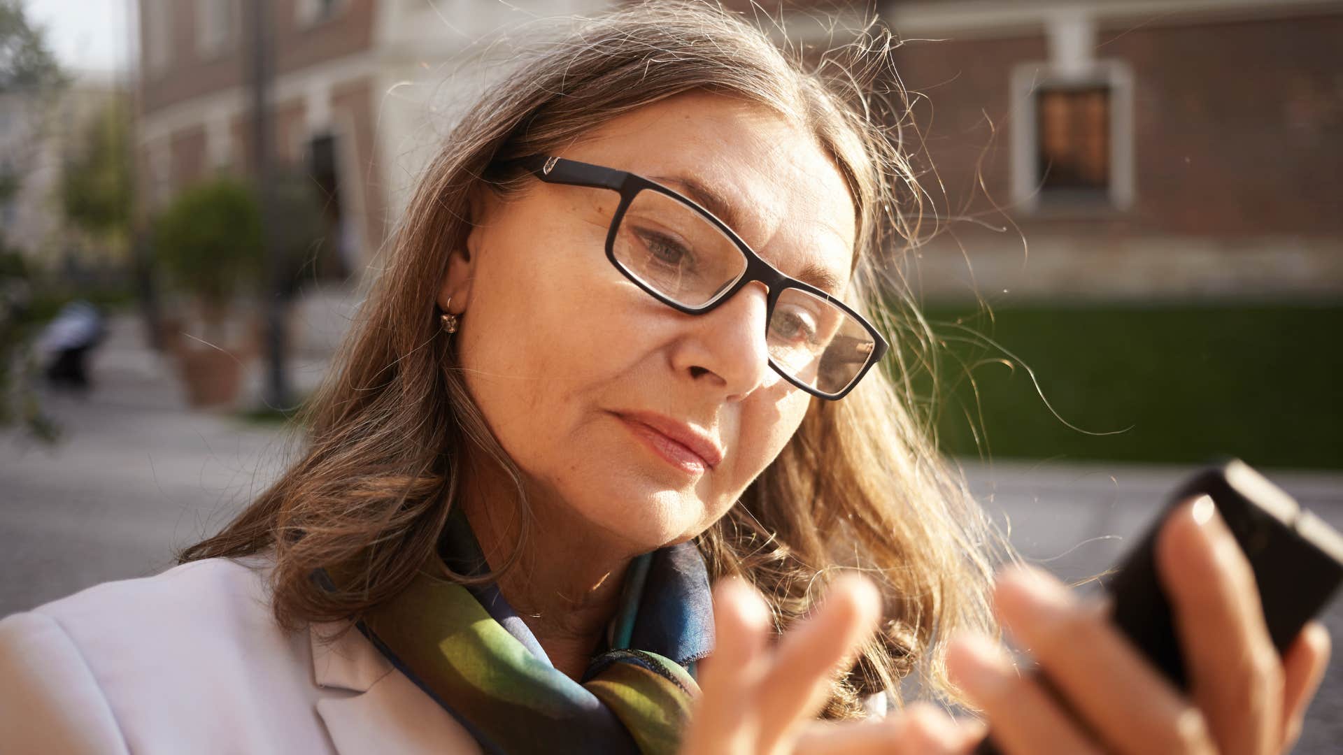 woman thinking about her phone's consequences on mental health
