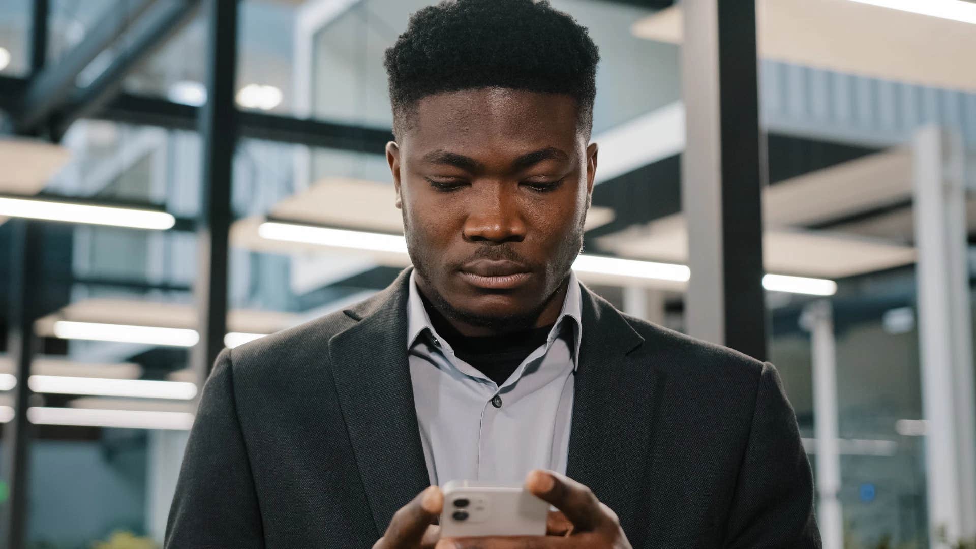 man scrolling on phone dependent on social media