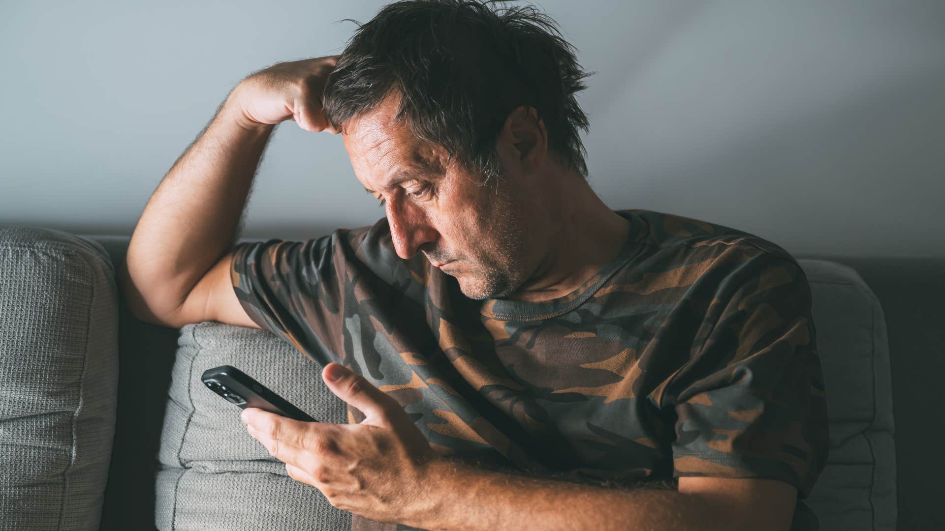 man on his phone complaining about the superficiality on social media