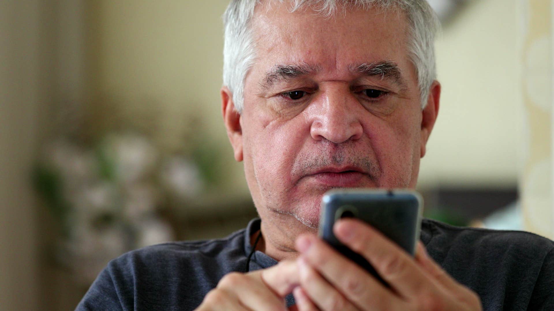 older man thinking about the time hes wasted on his phone