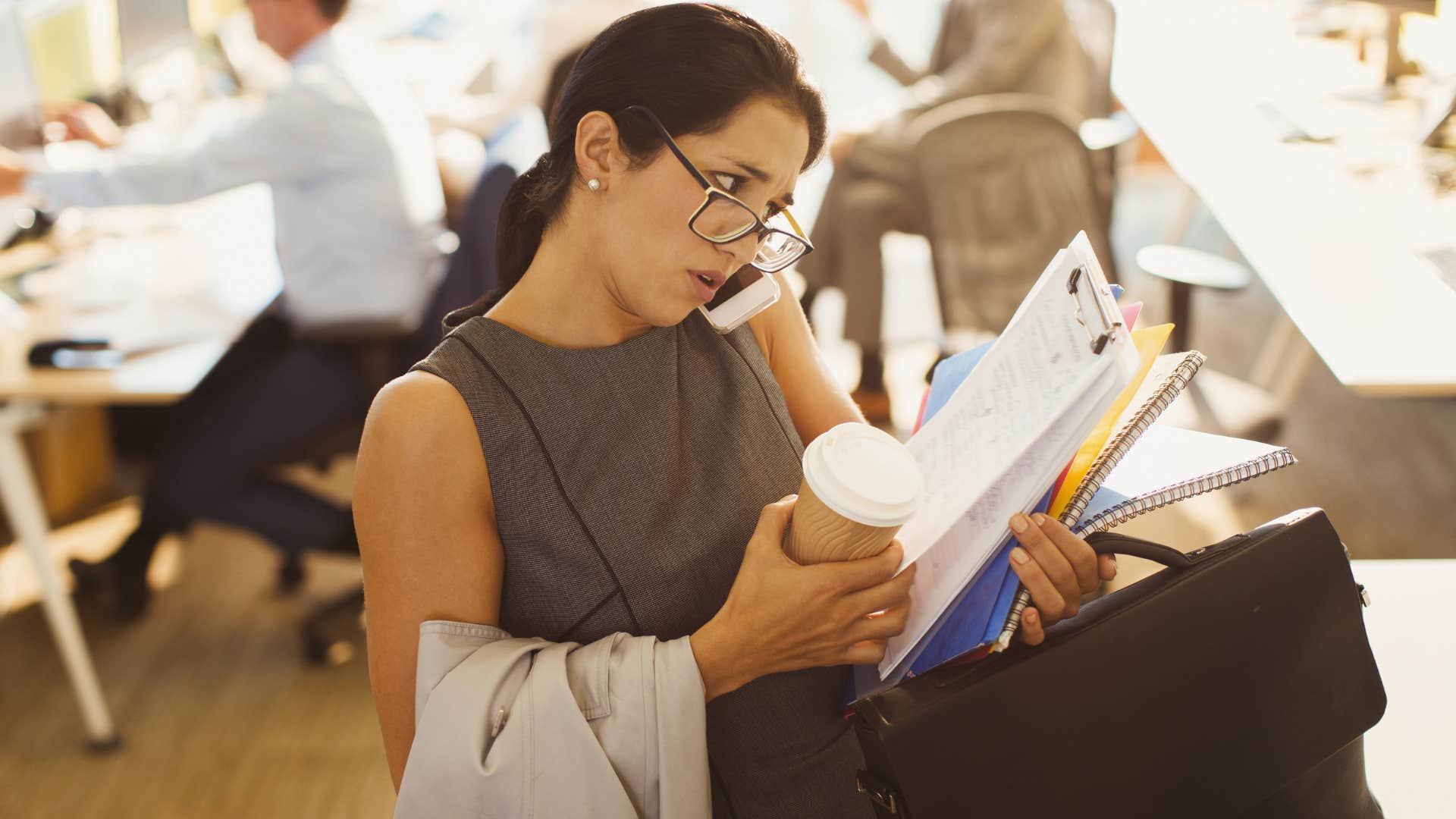 woman multitasking while leaving the office