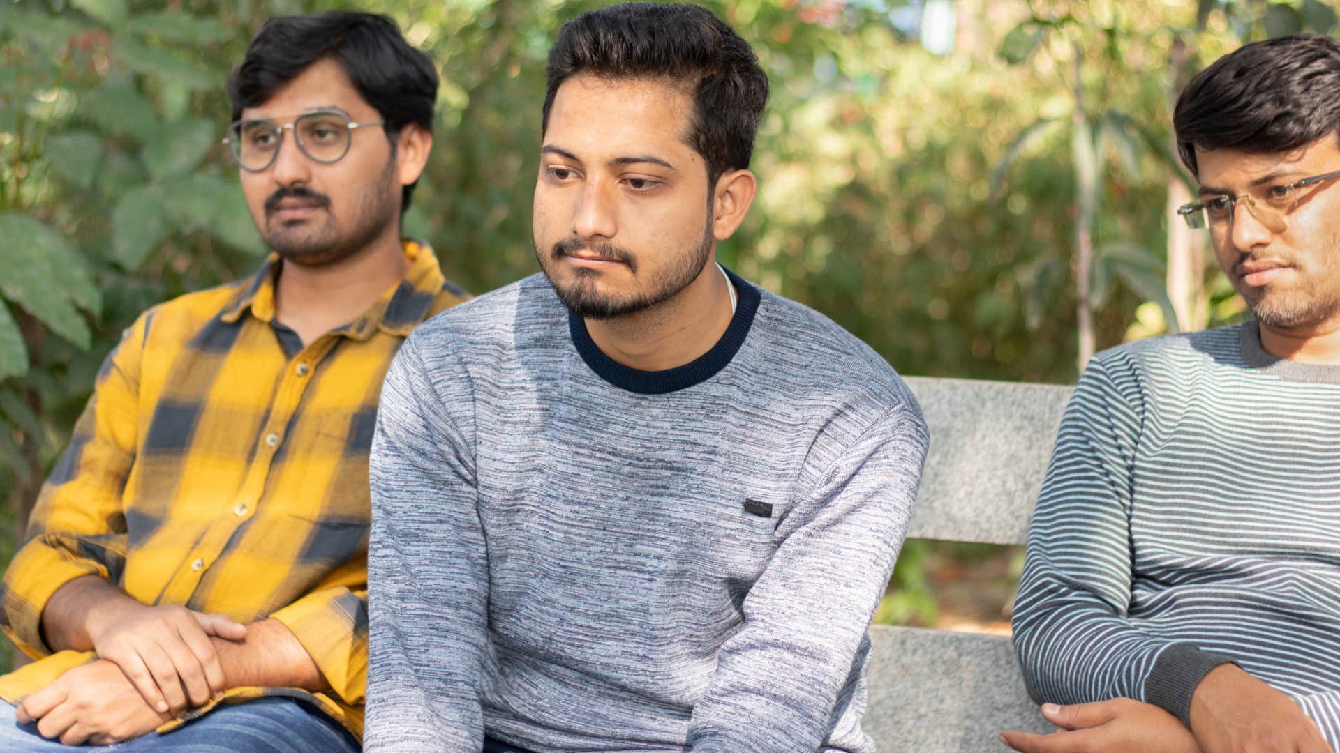 man surrounding himself with passive friends sitting outside