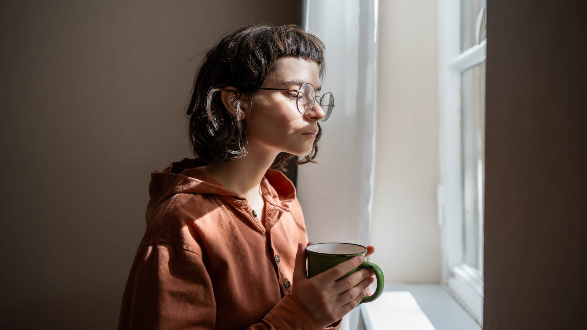 introverted person looking out the window