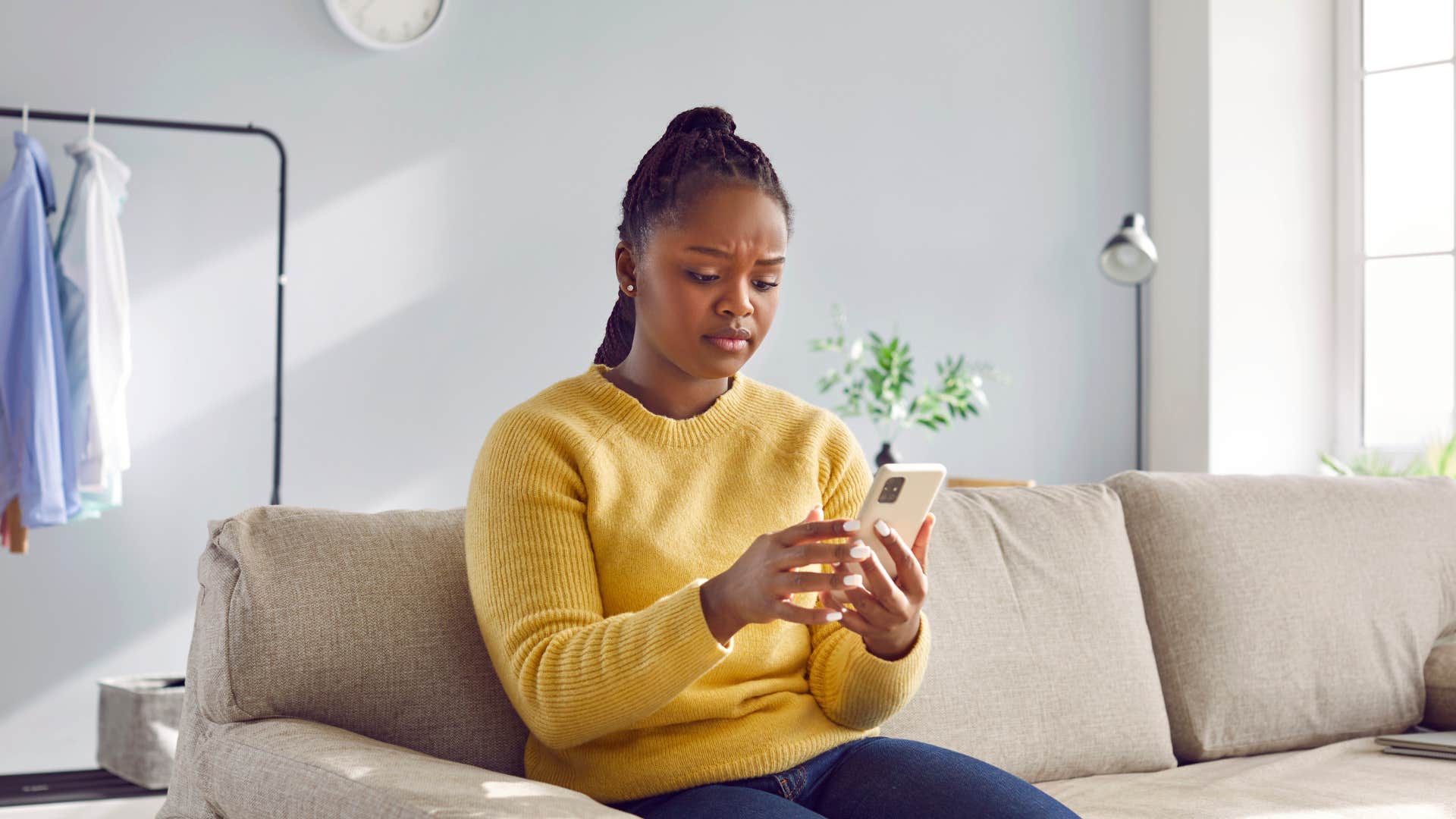 upset woman looking at phone after not taking credit for something