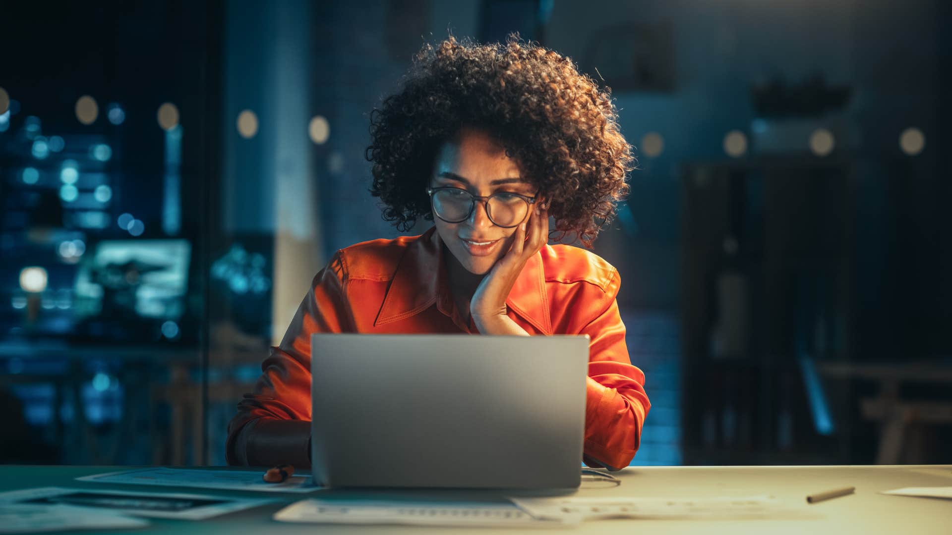 perfectionist woman working on laptop at desk