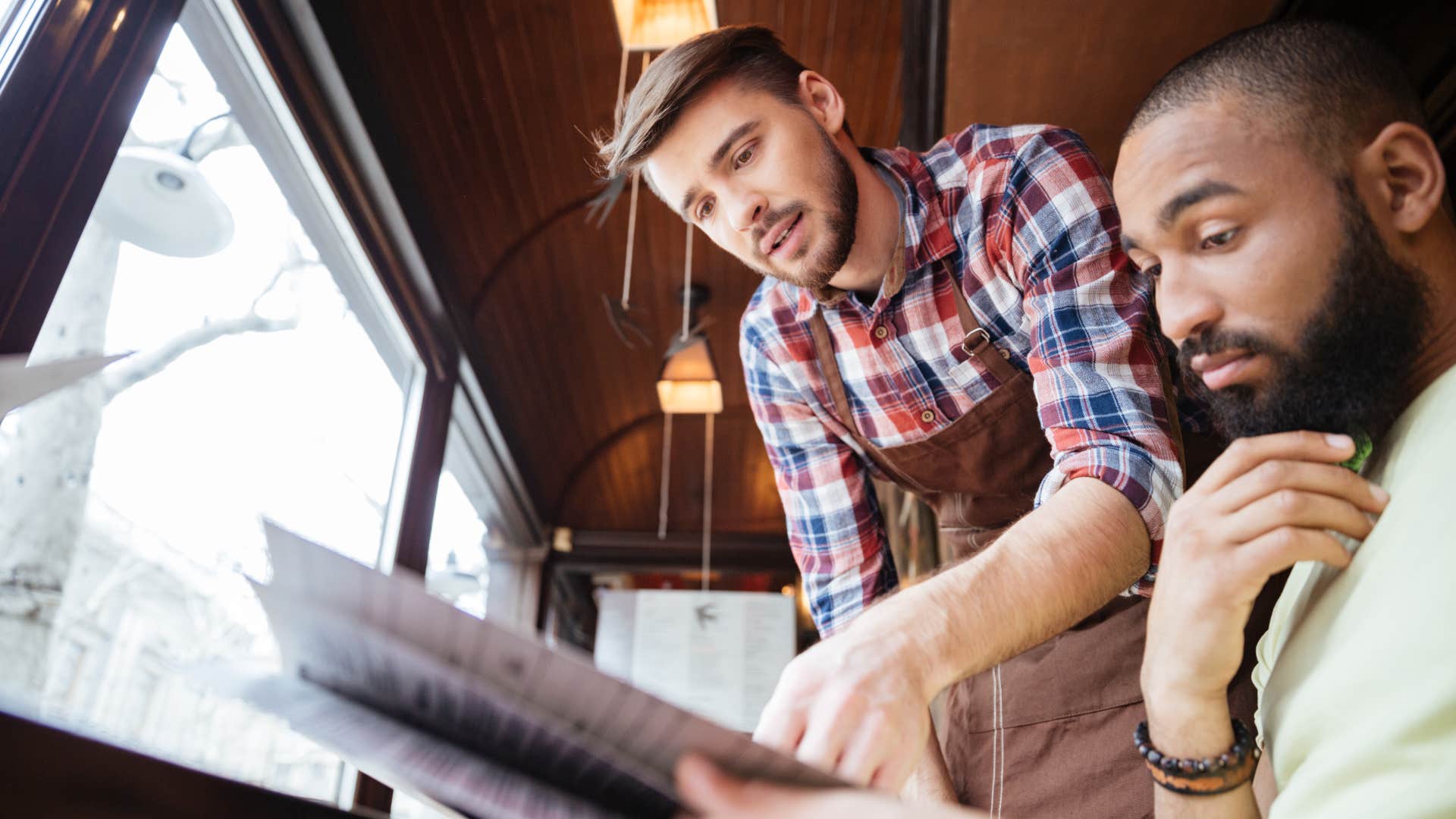 man Asking the server what they like which is a polite going out to dinner habit that is actually disrespectful 