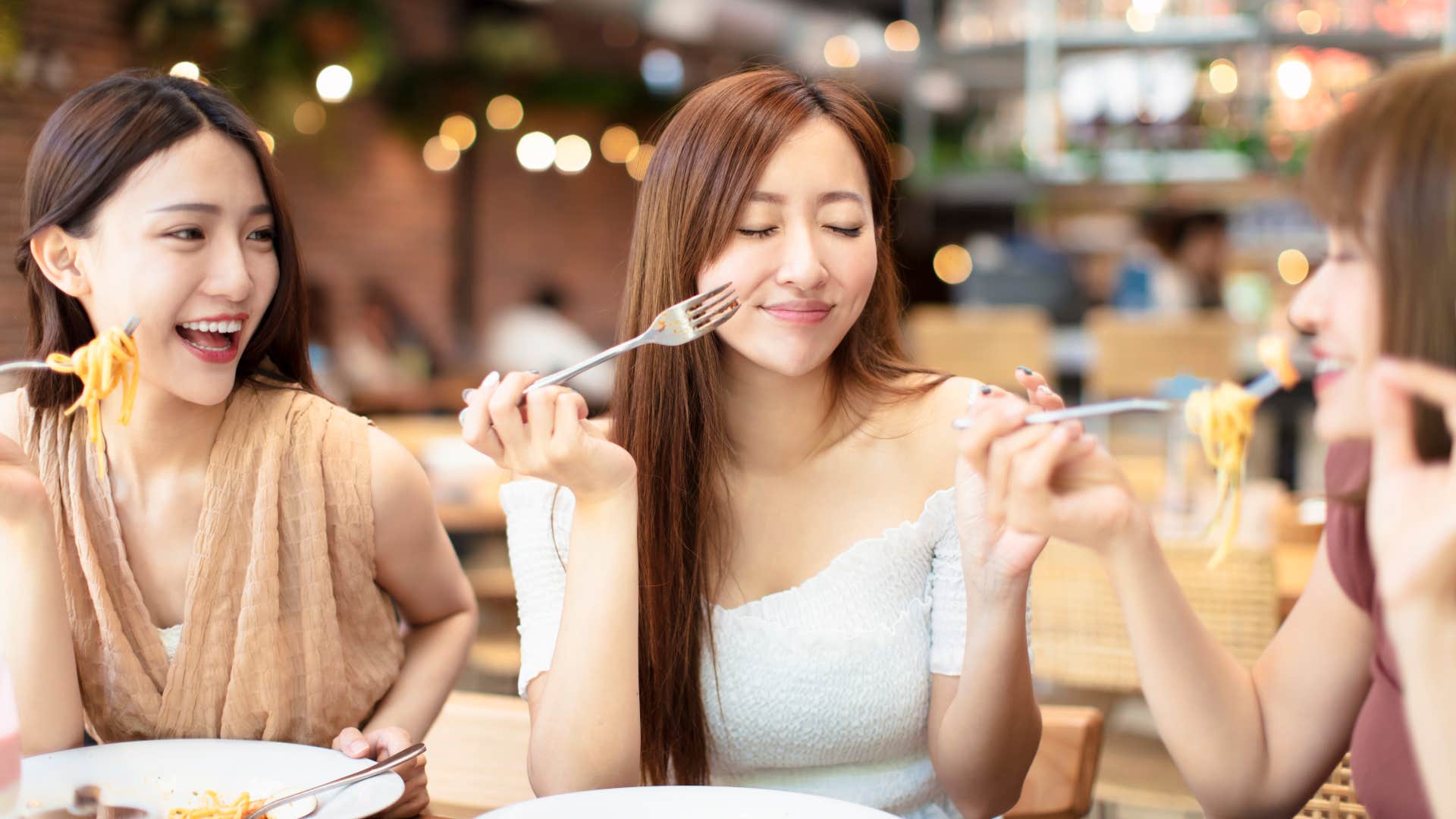 woman is Correcting someone’s manners mid-meal which is a polite going out to dinner habit that is actually disrespectful 