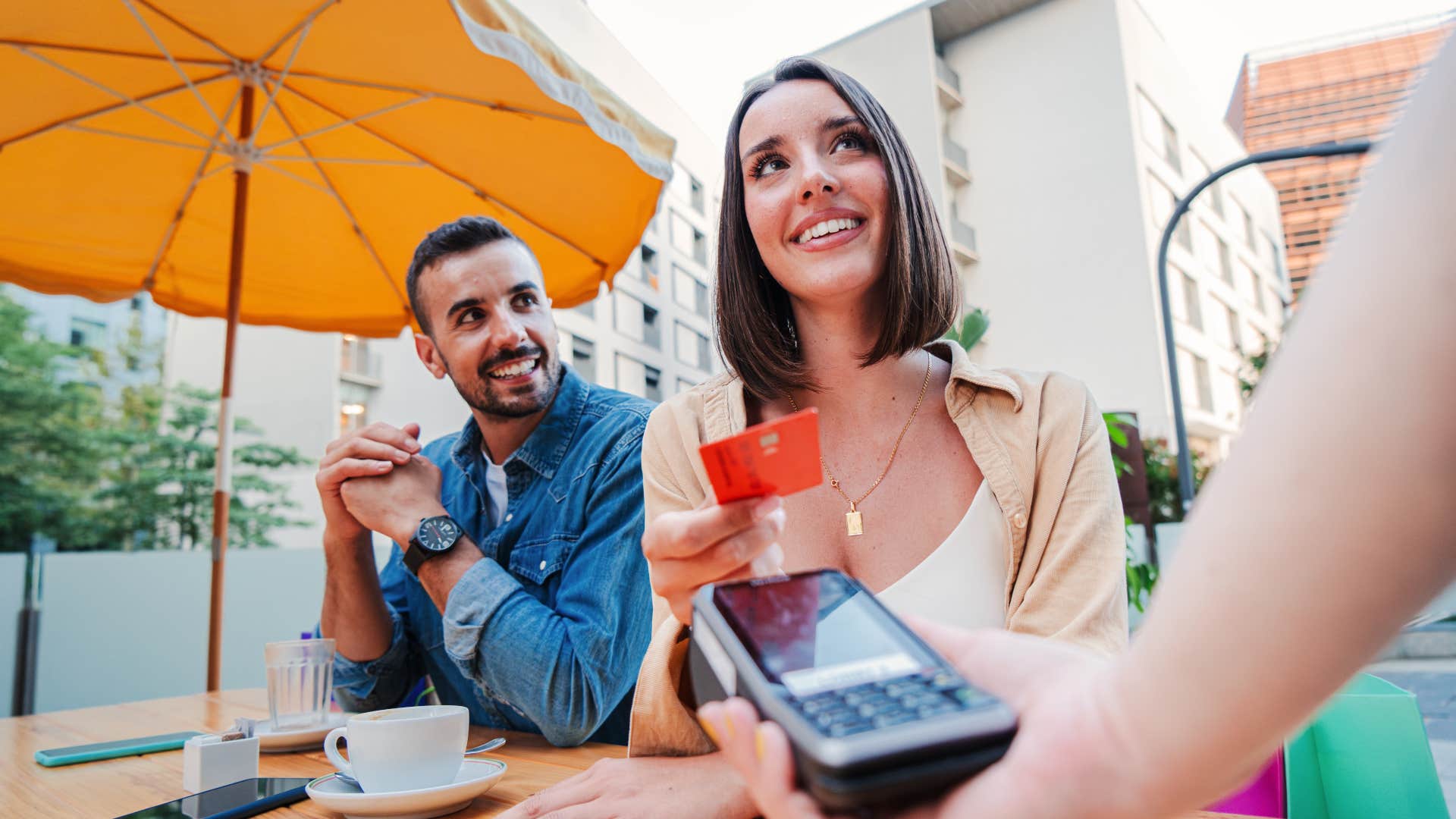 woman is Paying without checking the bill which is a polite going out to dinner habit that is actually disrespectful 