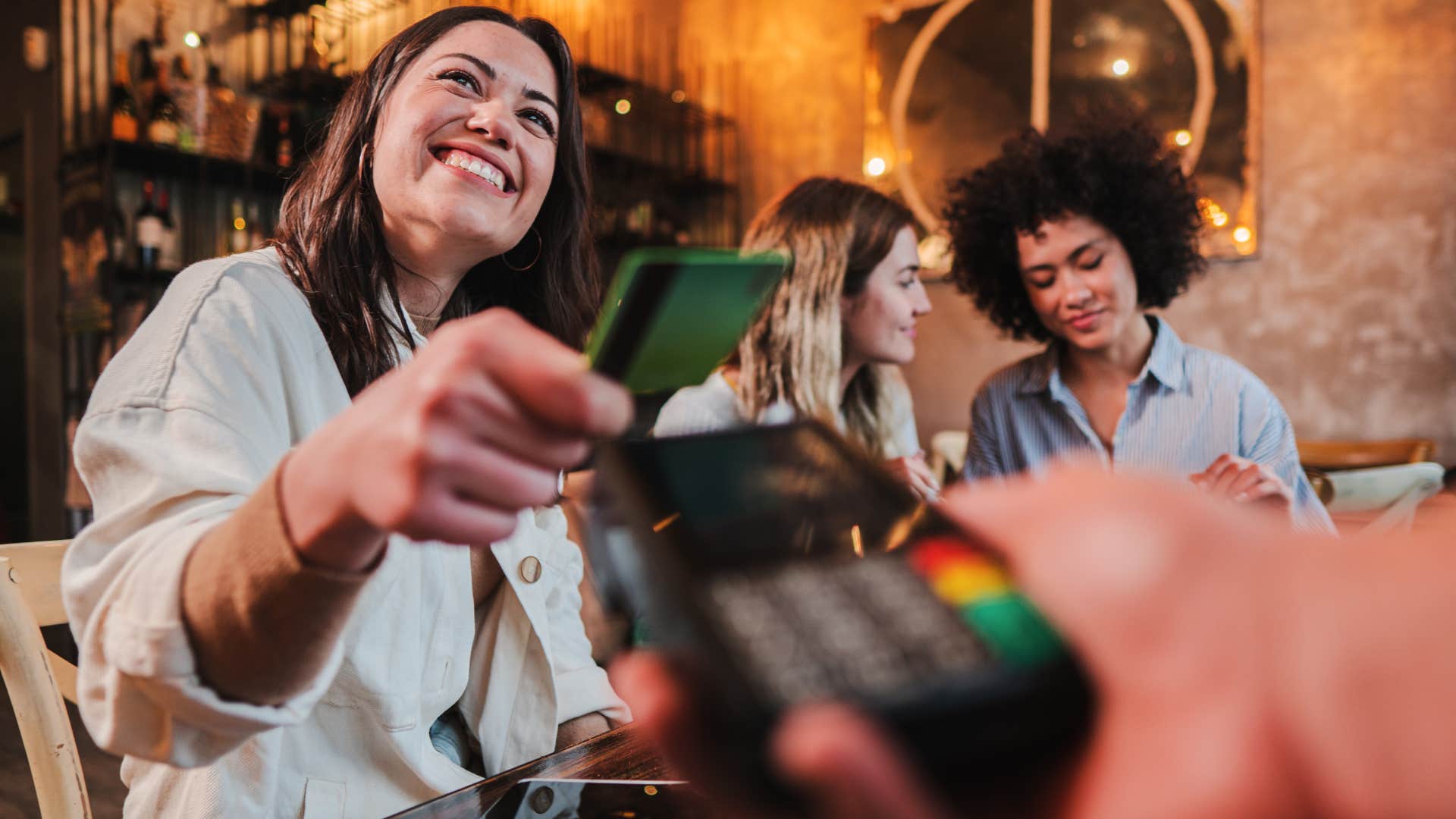 woman Paying for everyone without checking first which is a polite going out to dinner habit that is actually disrespectful 