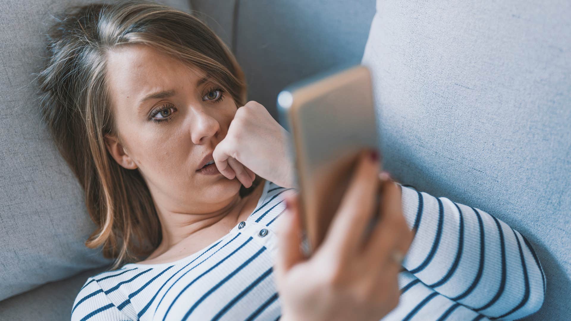 woman looking at her phone after breakup