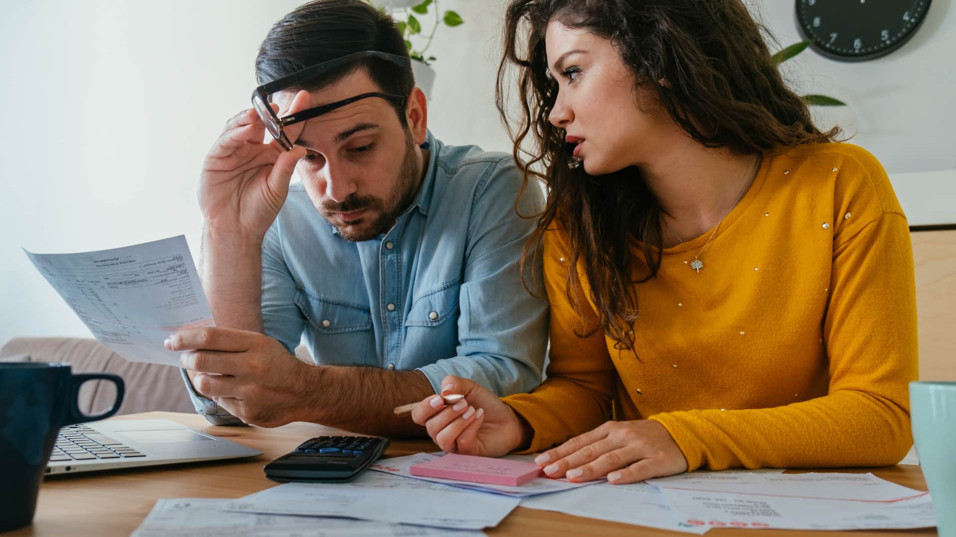 couple looking over finances deciding if theyre ready for a baby