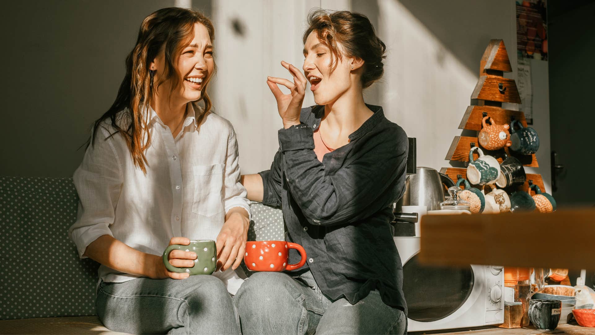 woman in black has a quirky sense of humor as she feeds woman in white