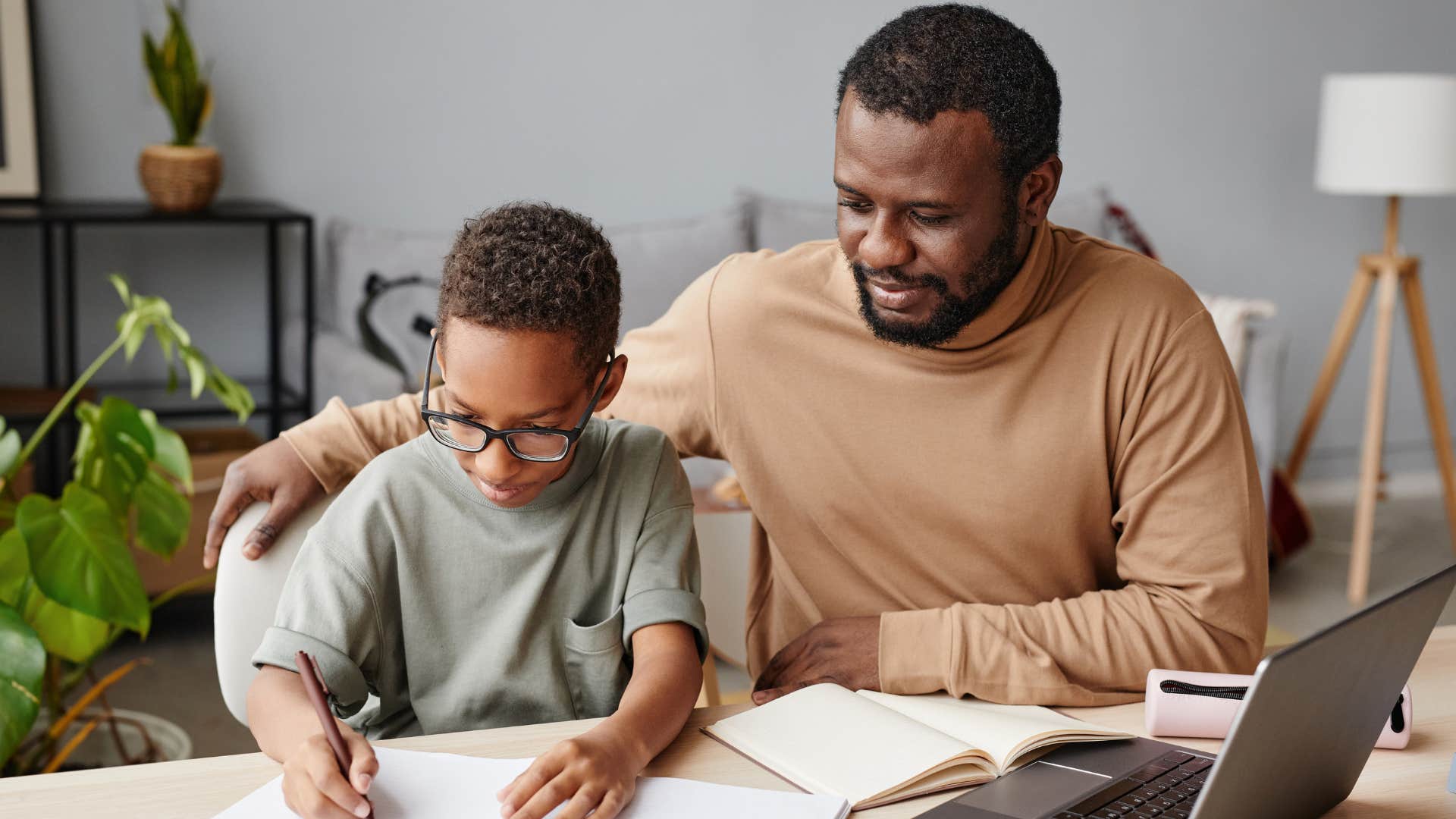dad who wants his son to focus on academics helping with homework