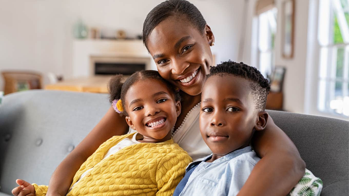 wealthy mother smiling with her kids on the couch