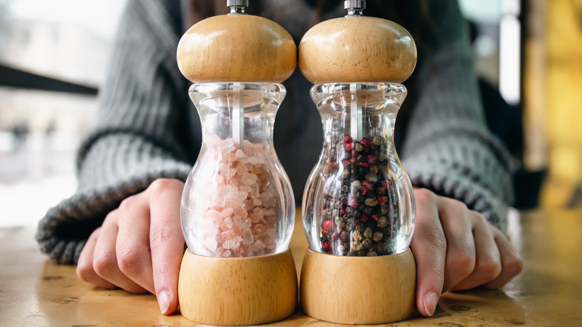 person passing the salt and pepper for dinner