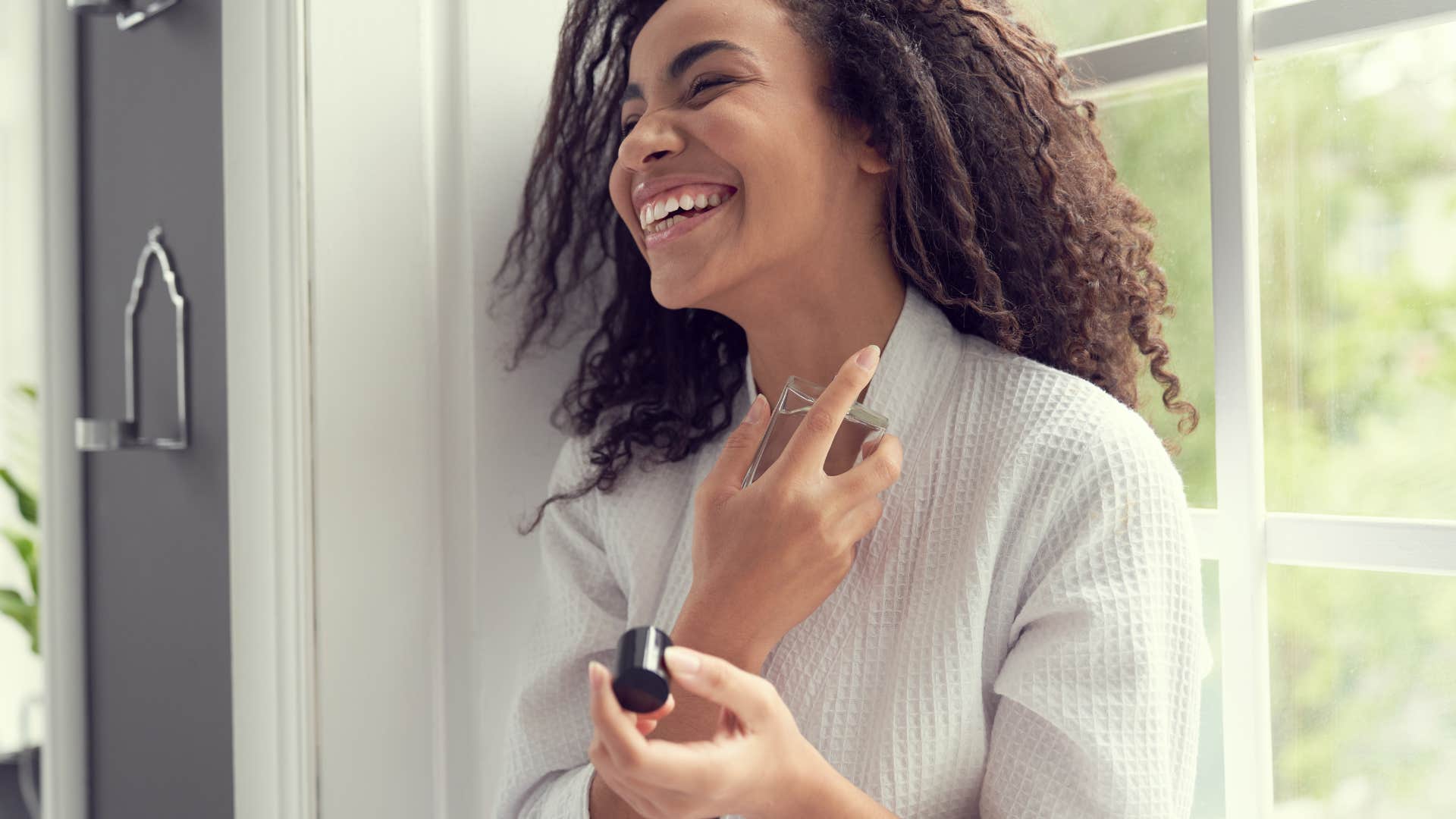 high society woman putting on perfume