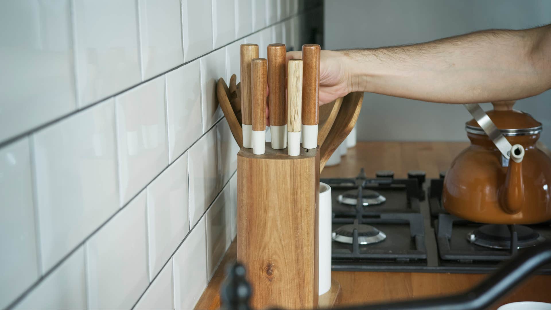 woman telling out knife from full knife block set