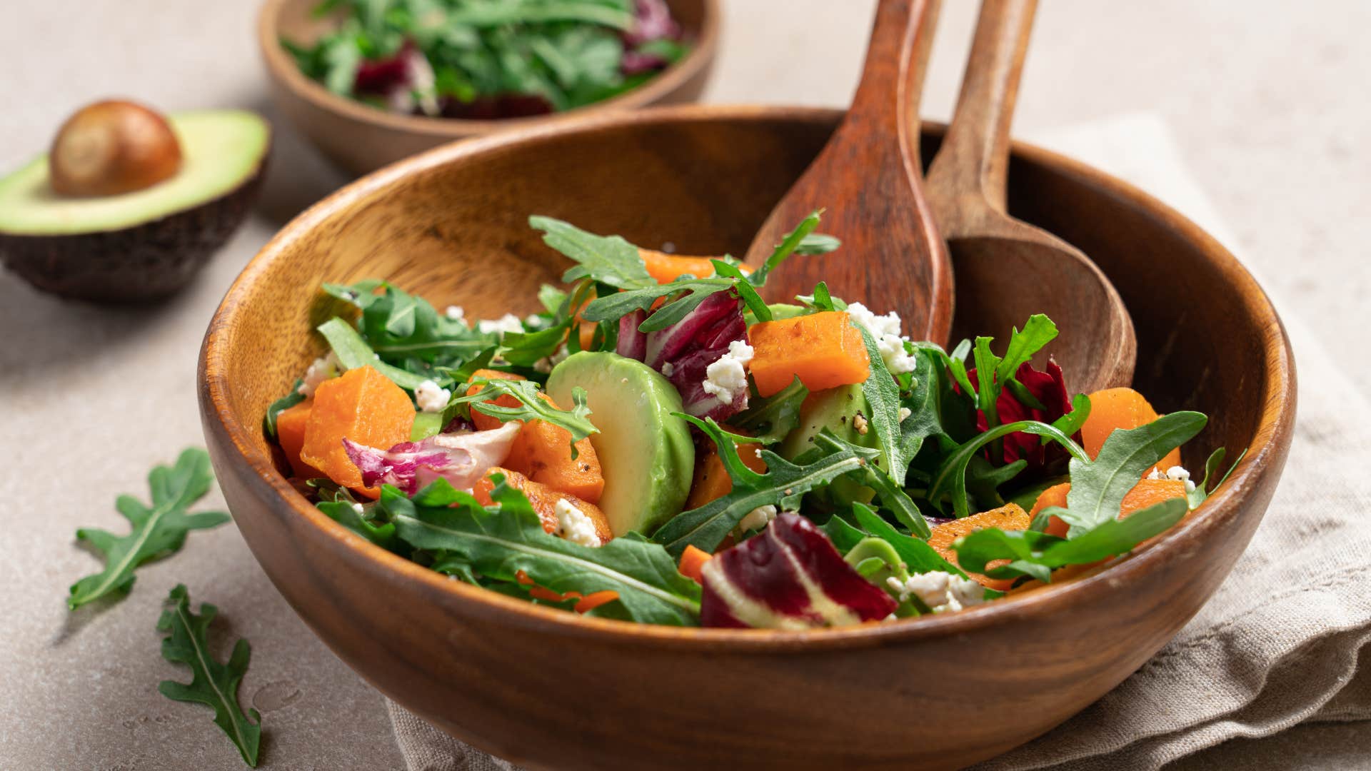 a giant wooden salad bowl filled with salad