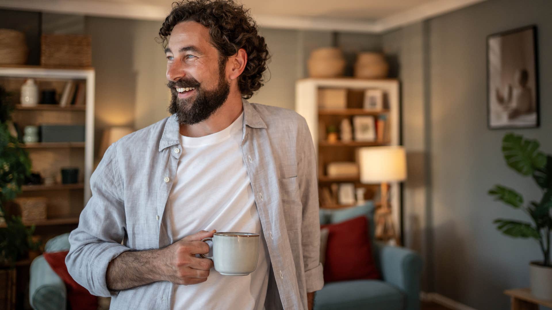 man who's not afraid of being alone smiling at home
