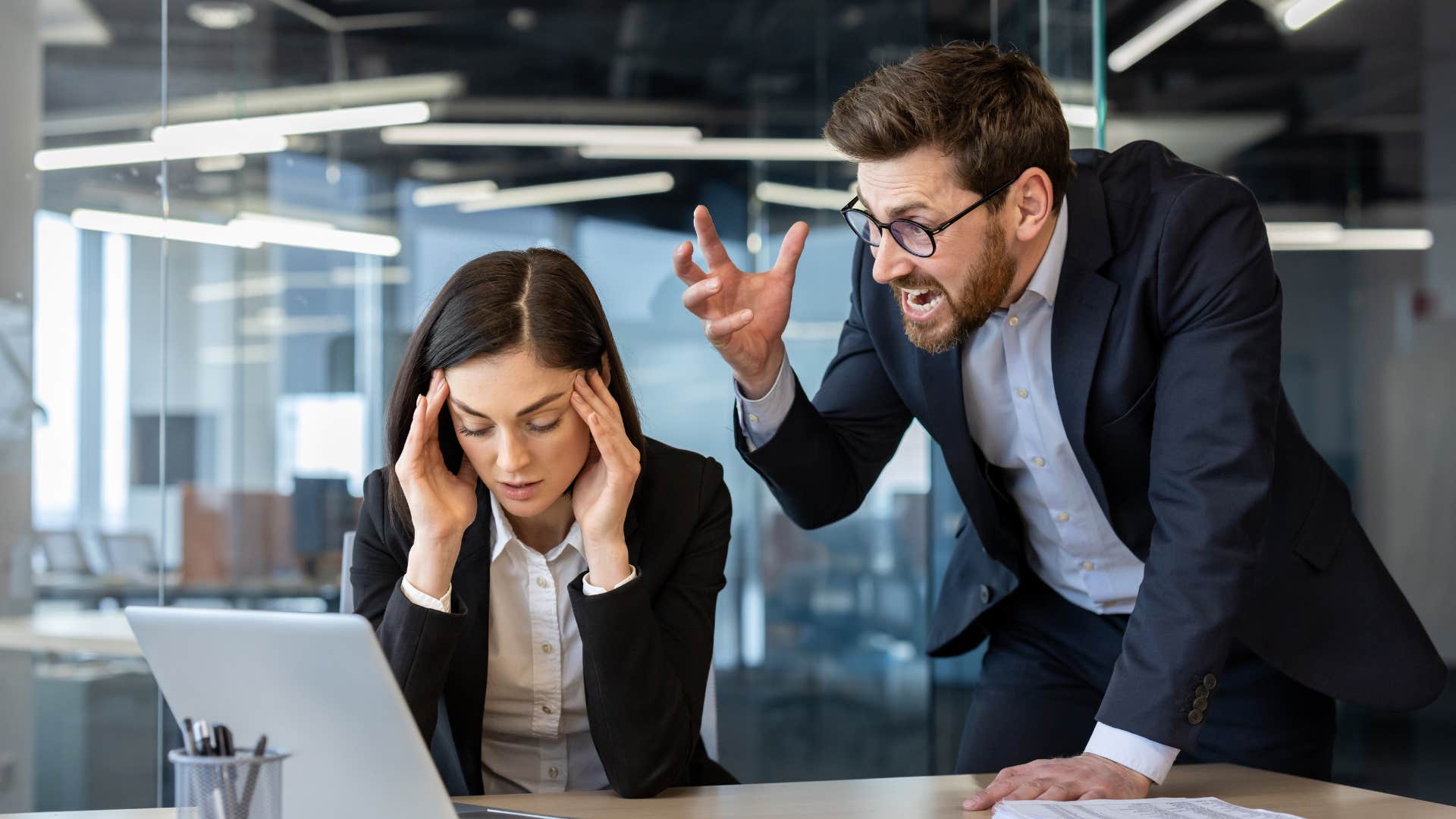 misogynistic man berating woman at work competing with her