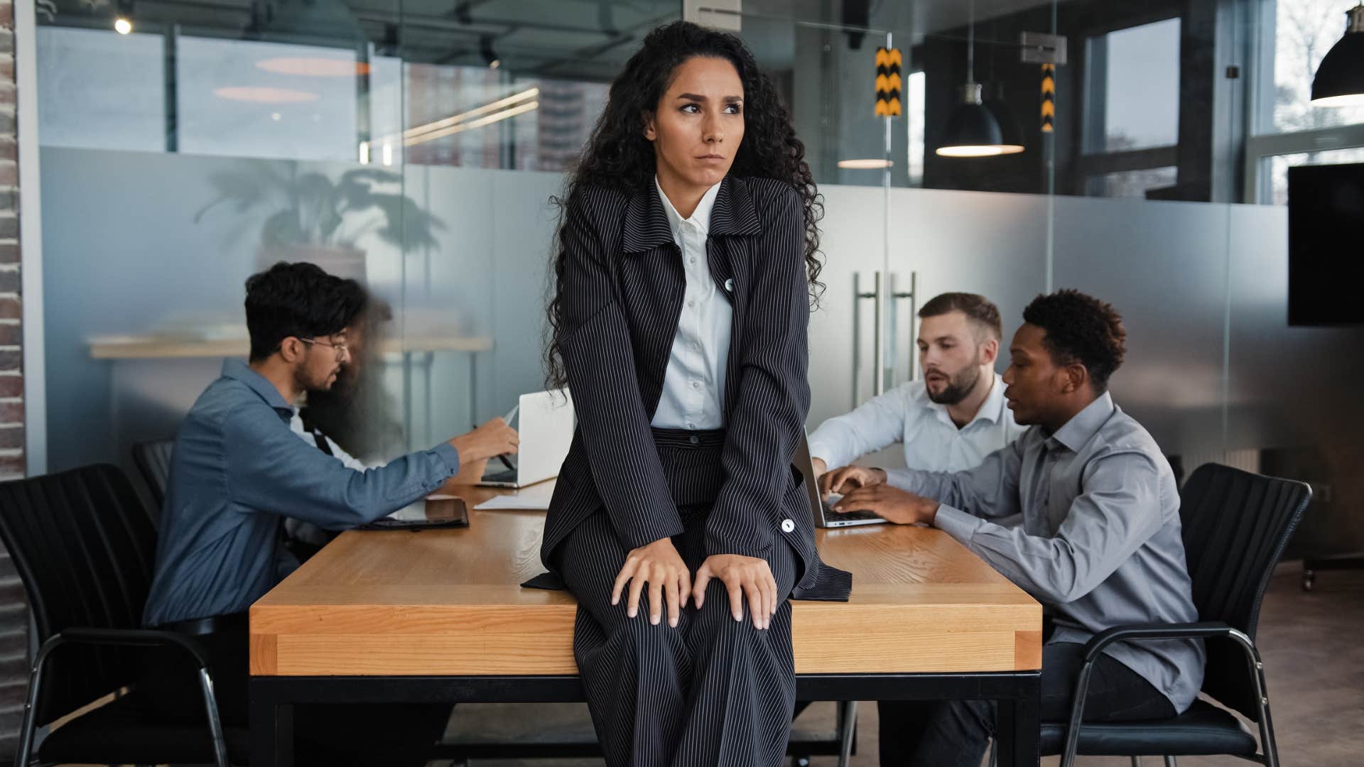 misogynistic men ignoring female colleague at work