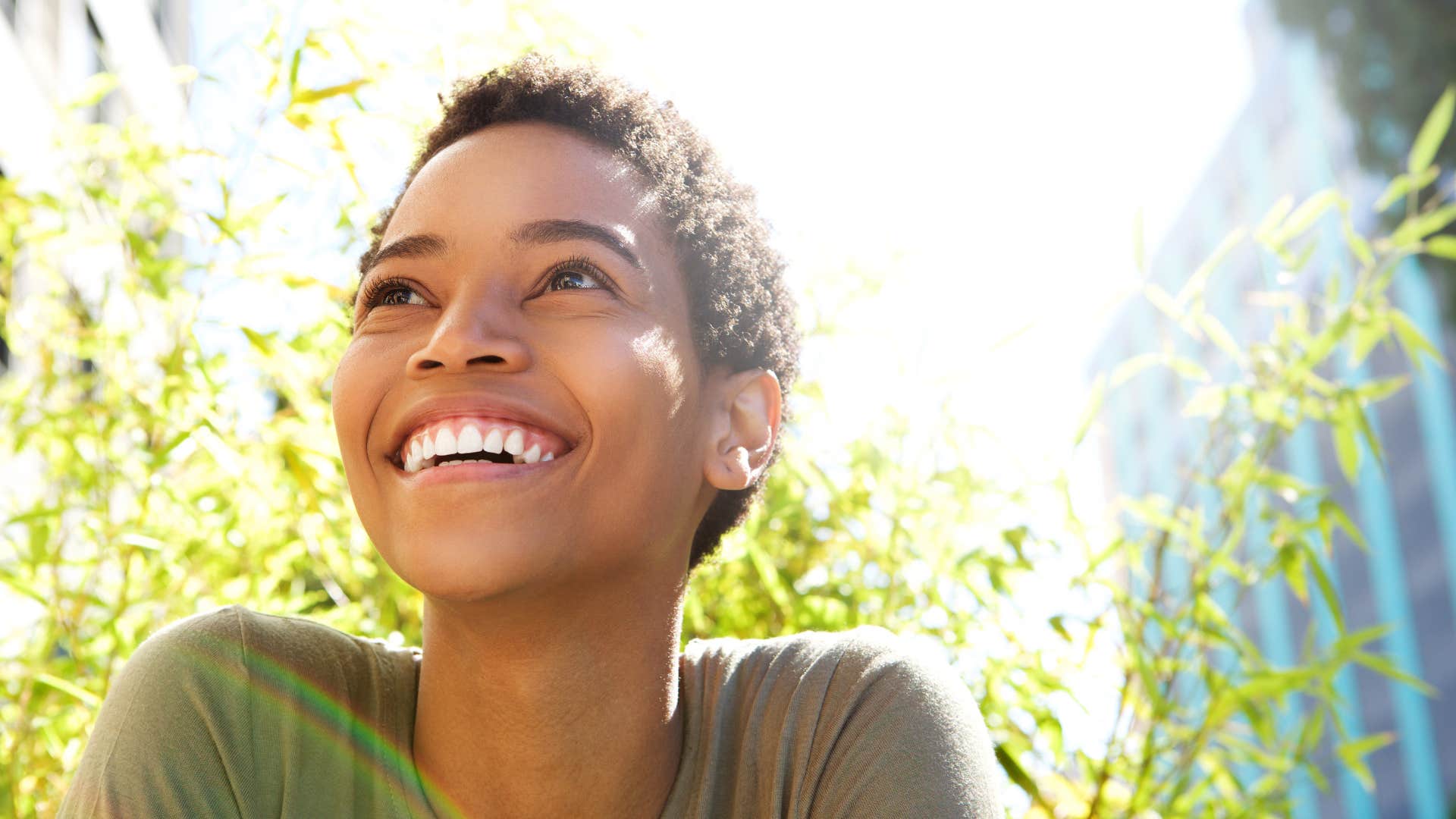 woman smiling while sitting outside
