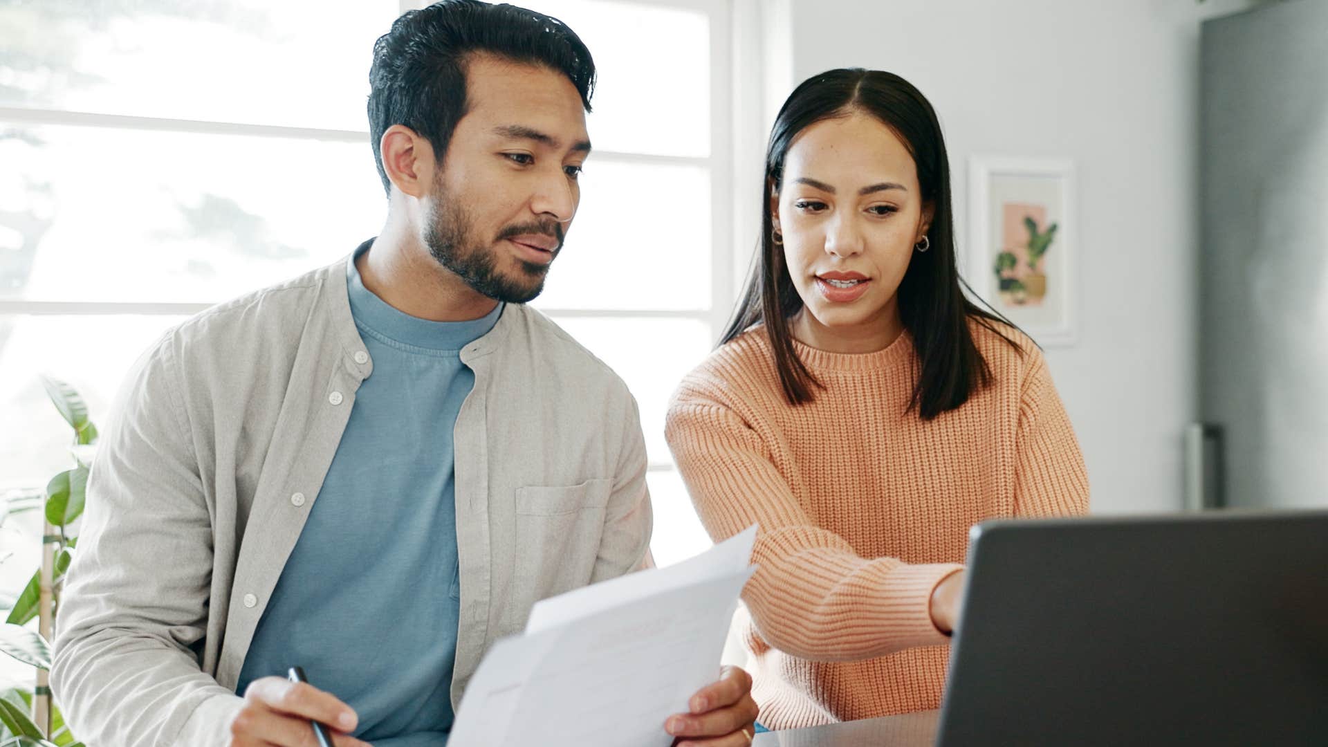 Couple with enough money to pay all their bills sitting at home.