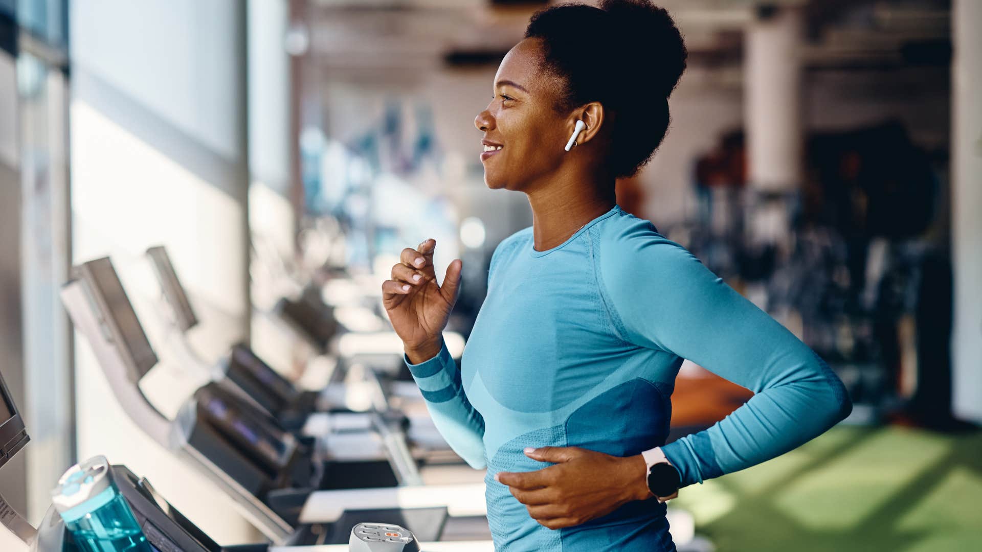 Woman whose gym membership costs more than her phone bill running on a treadmill.