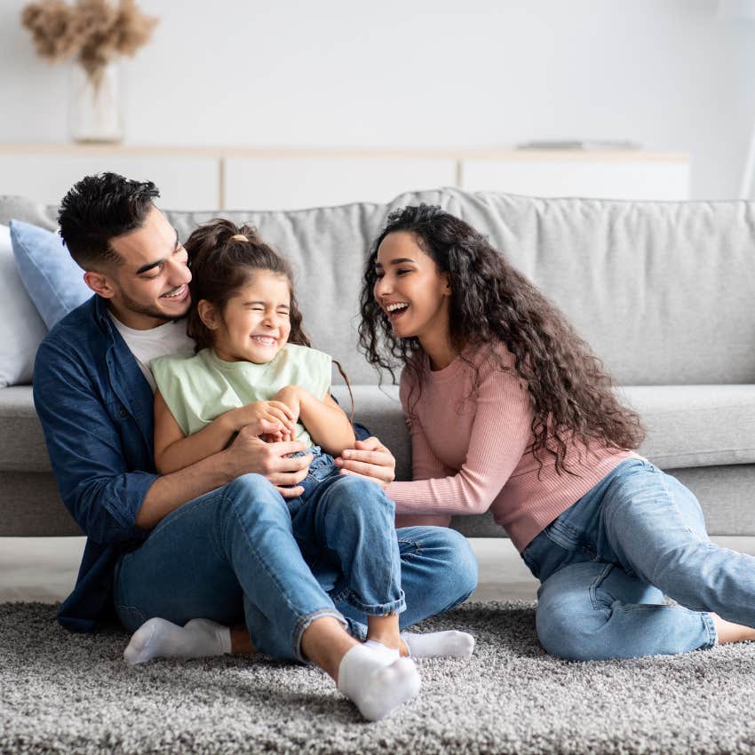 joyful people playing with their child