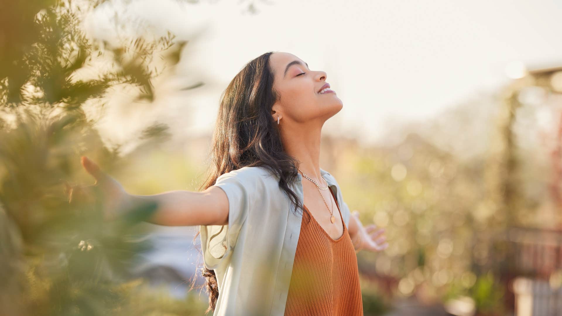 woman who is naturally peaceful listening to birds singing
