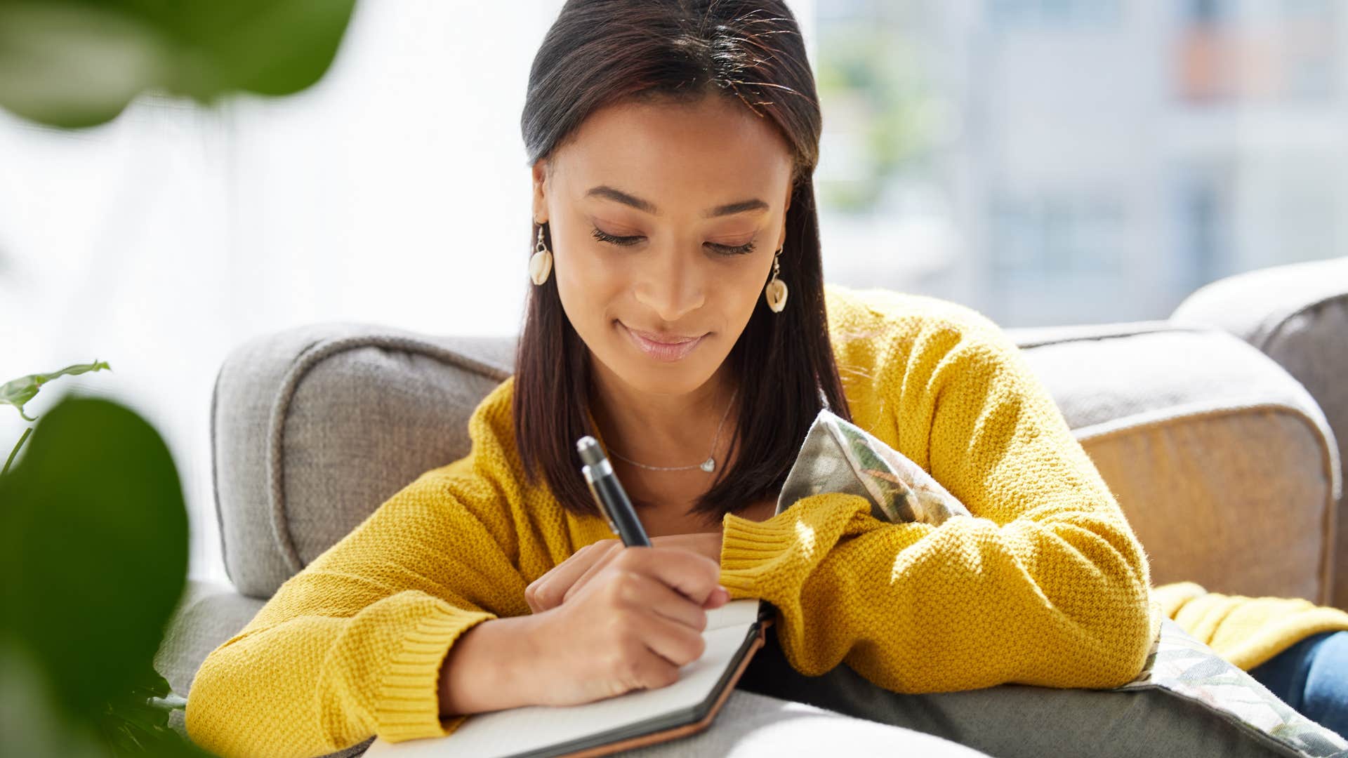 woman who is naturally self-aware as she writes thoughts down