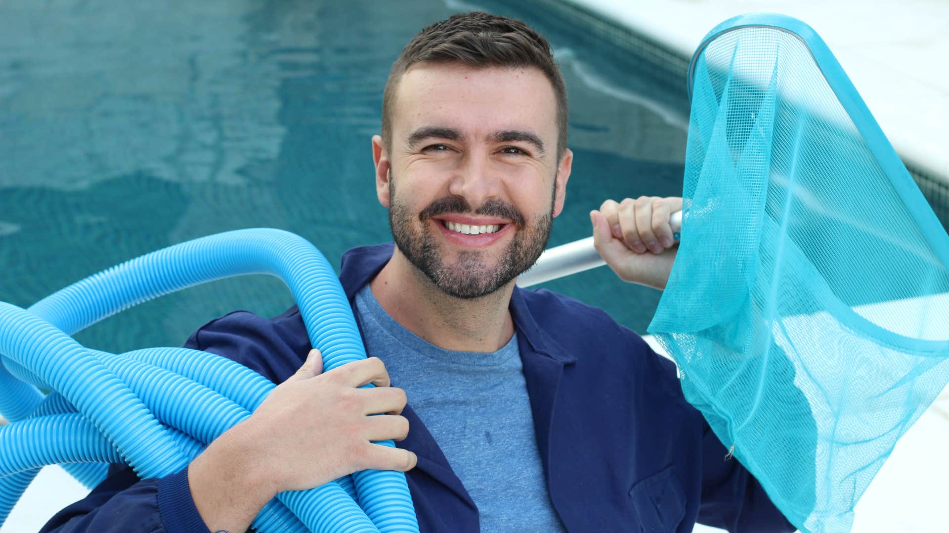 middle class man carrying items to his own pool
