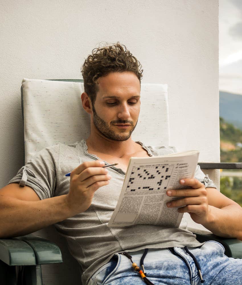highly intelligent man doing crossword puzzle
