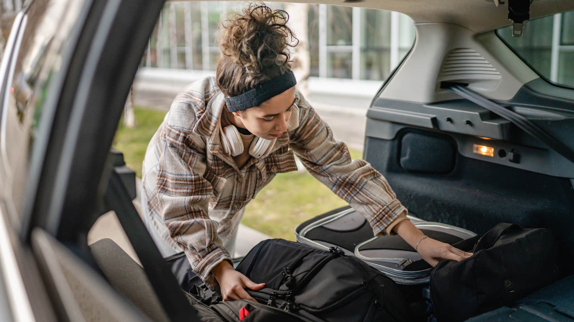 woman clearing out car trunk