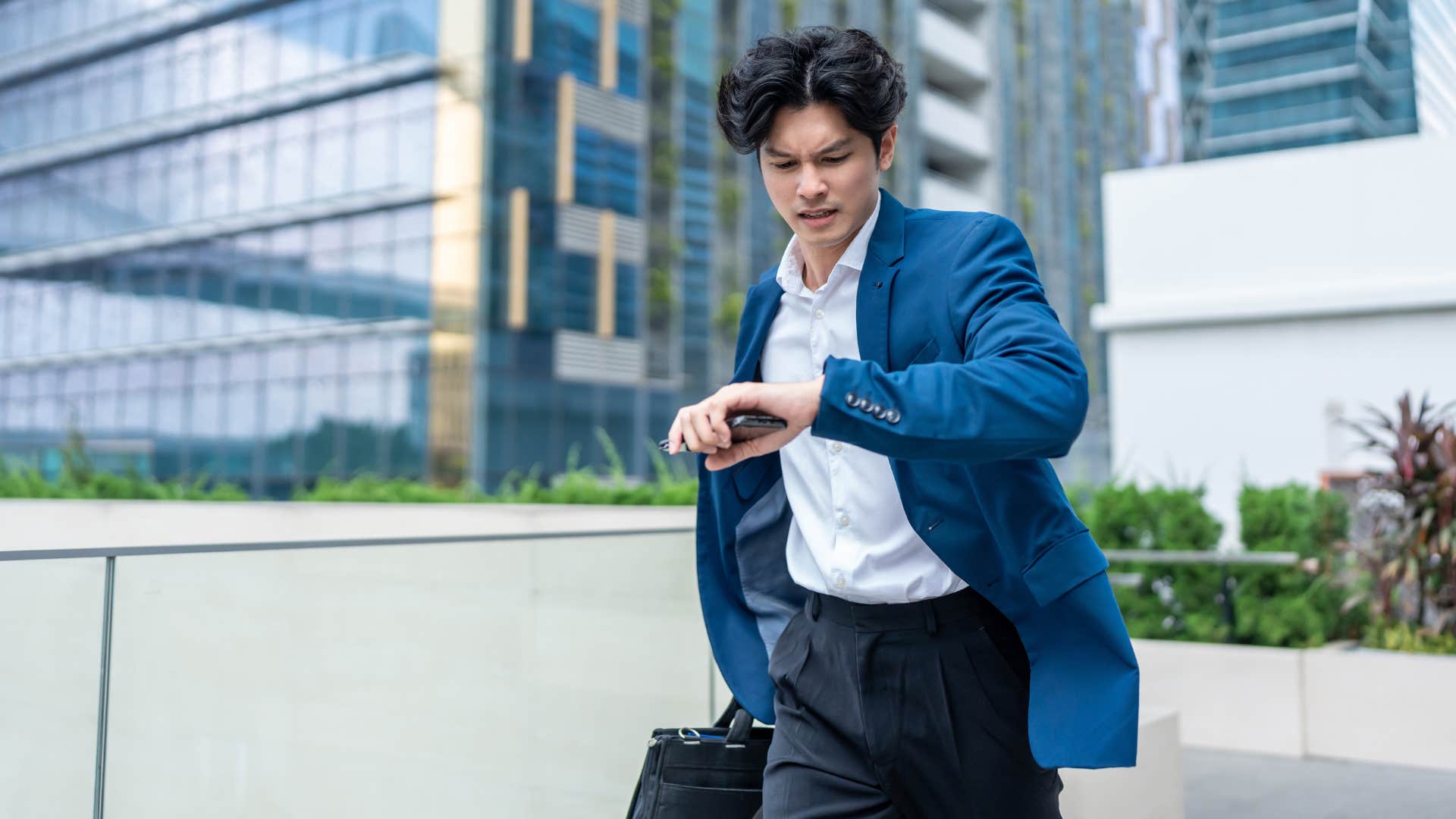 man running late looking at watch