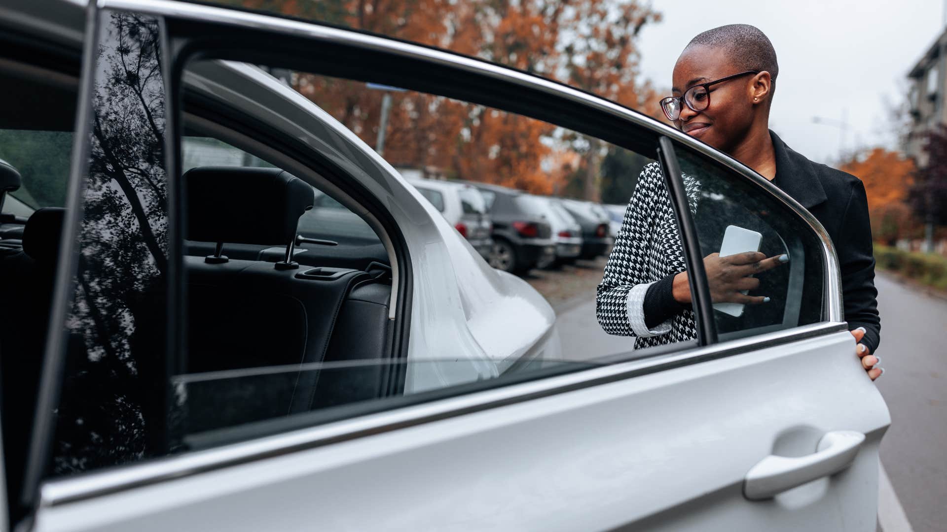 woman getting into the backseat of a car