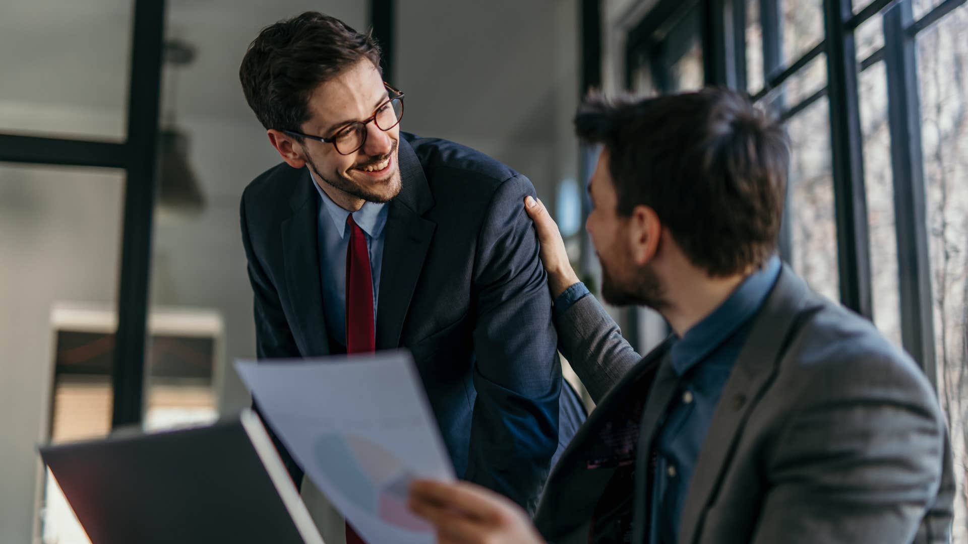 man in suit forgets basic social cues as boss greets him