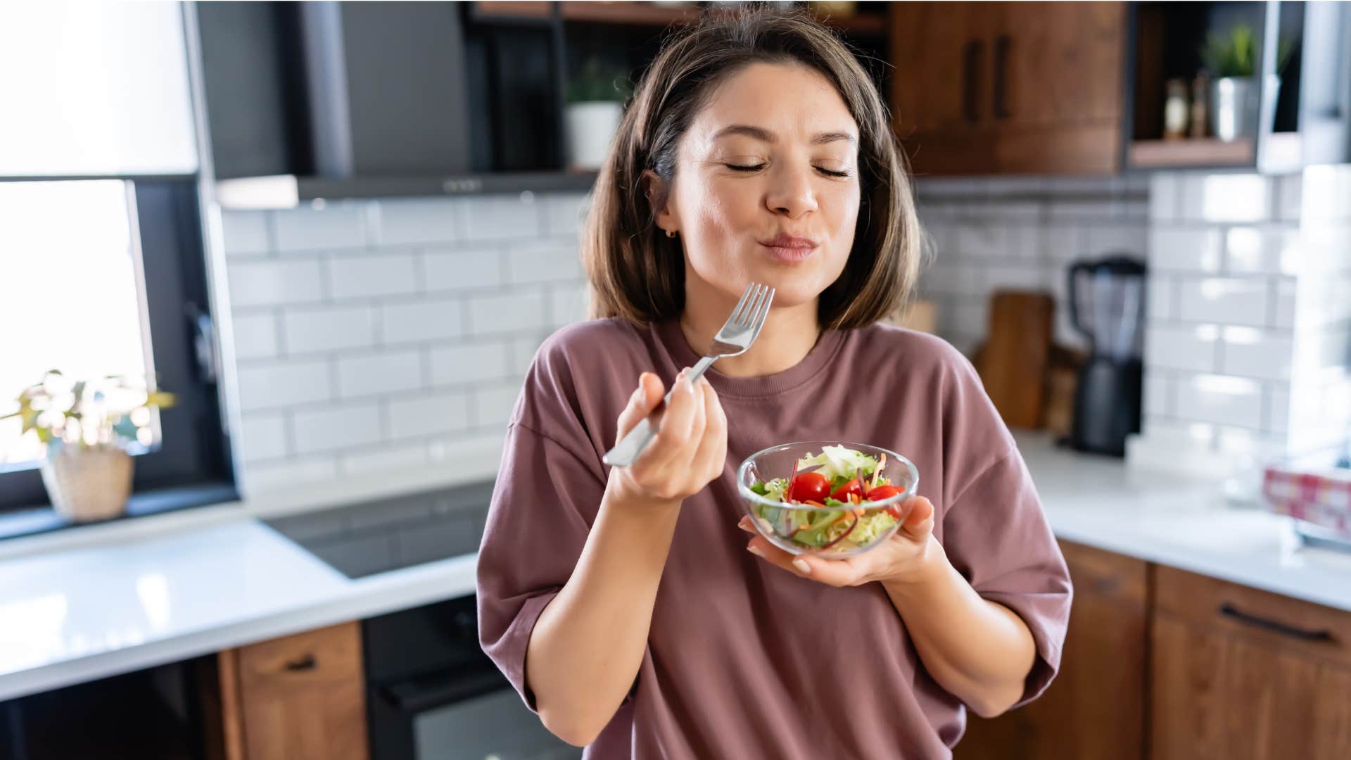 woman in brown shirt leaves food overnight and still eats it