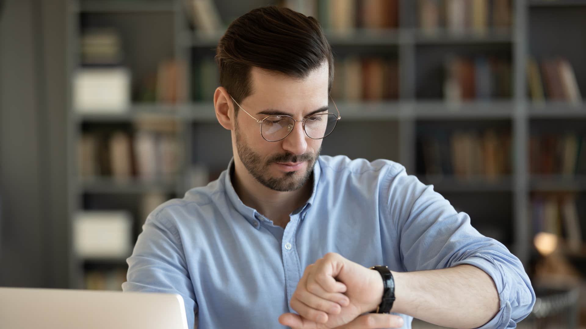man looking at watch thinking i don't have time for this