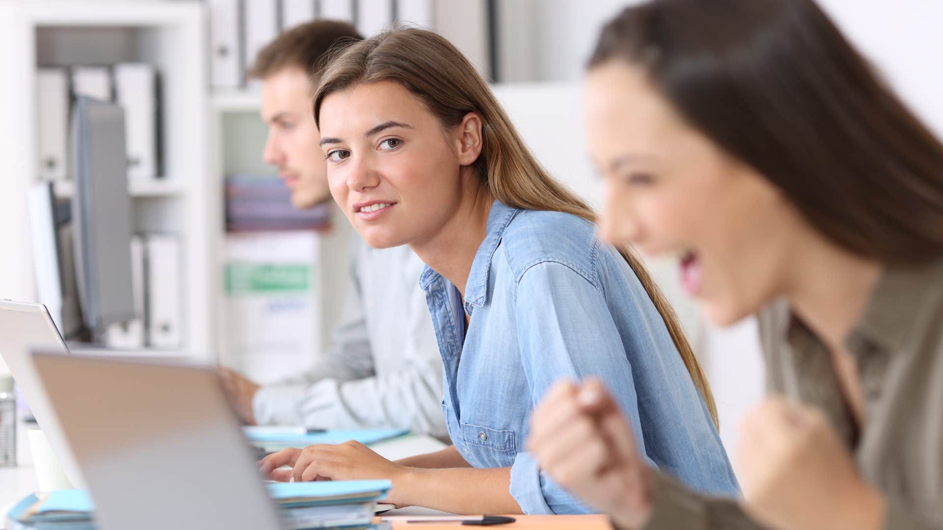 woman looking at colleague who's excited