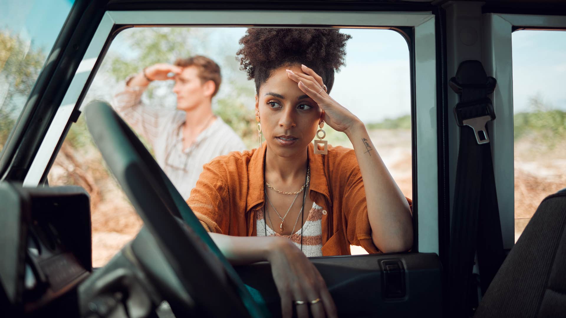 woman leaning on car ashamed to let friend in